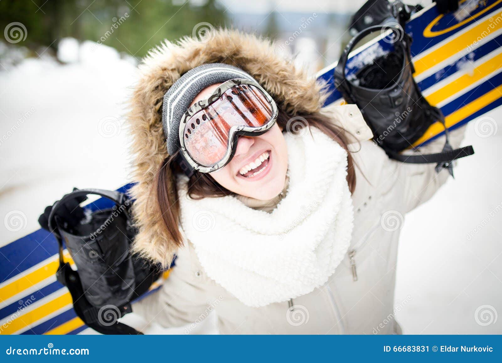 Snowboarding.Young Beautiful Woman with Ski Mask Holding Her 