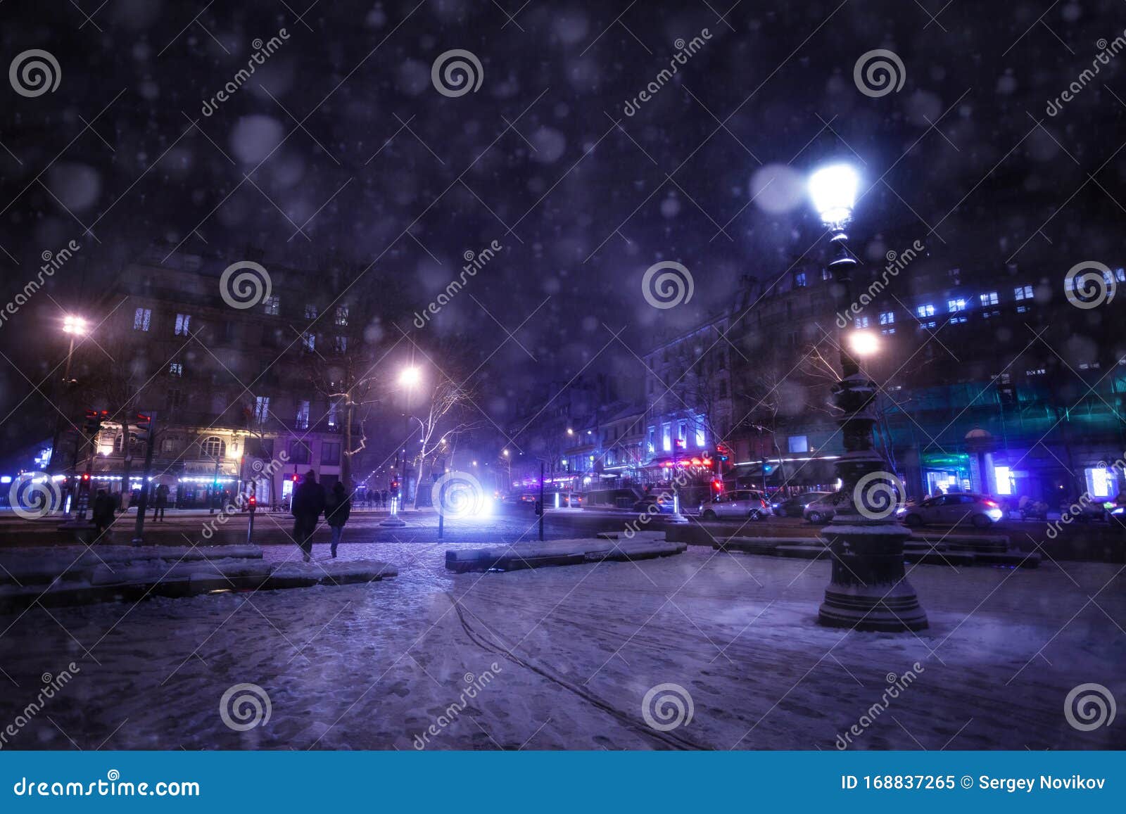 snowfall on republique square in paris at night