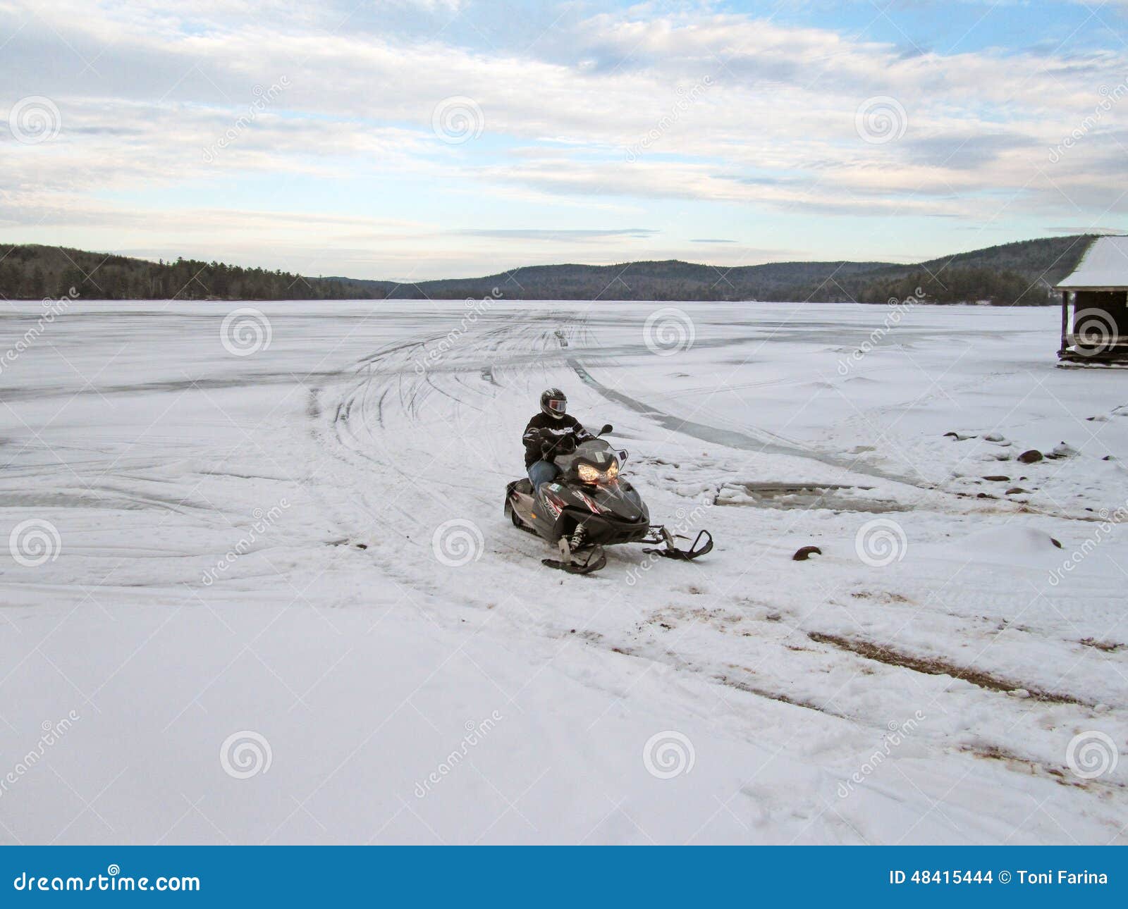 Snowmobile on Fourth Lake stock photo. Image of frozen 48415444
