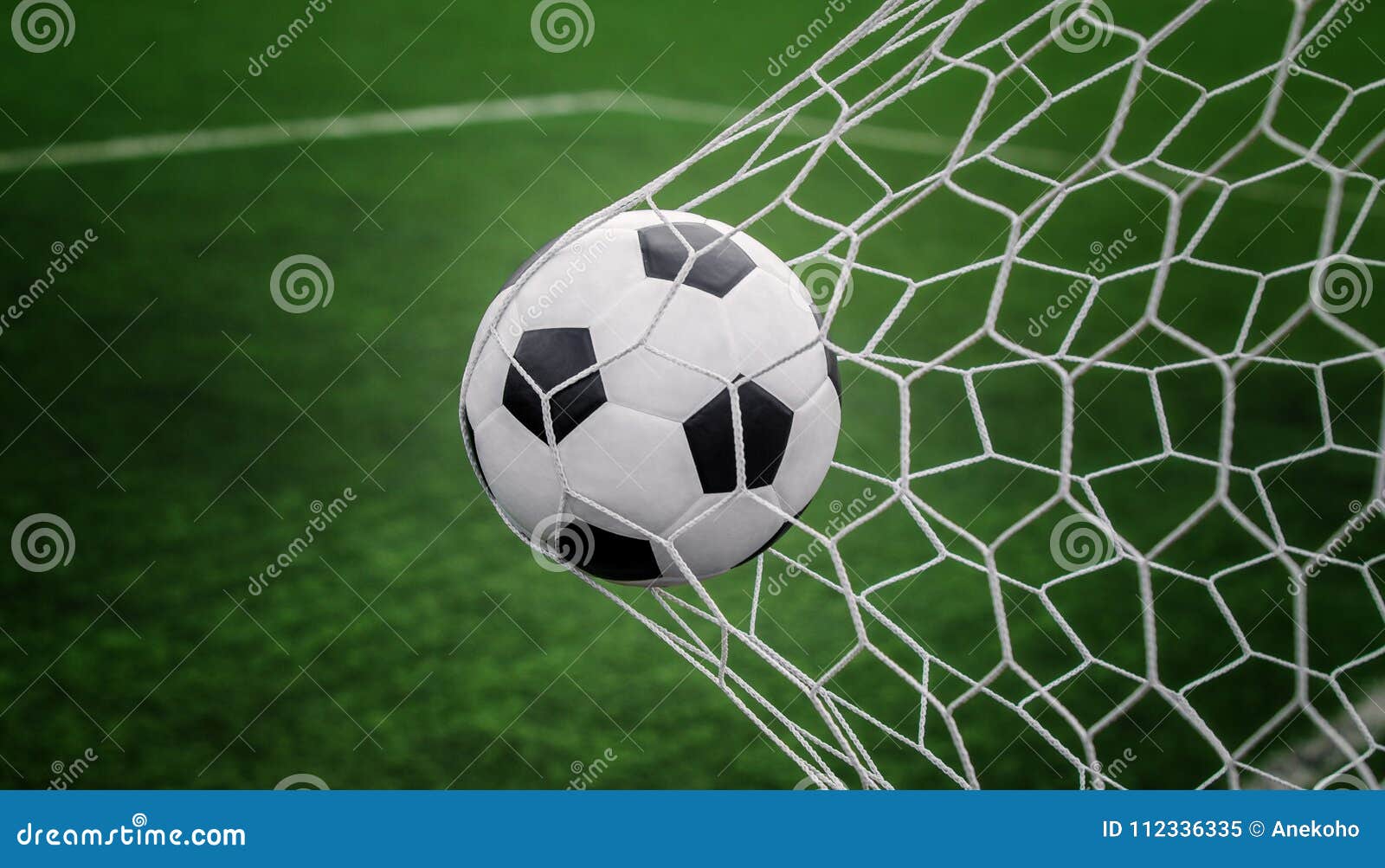 soccer ball on goal with net and green background