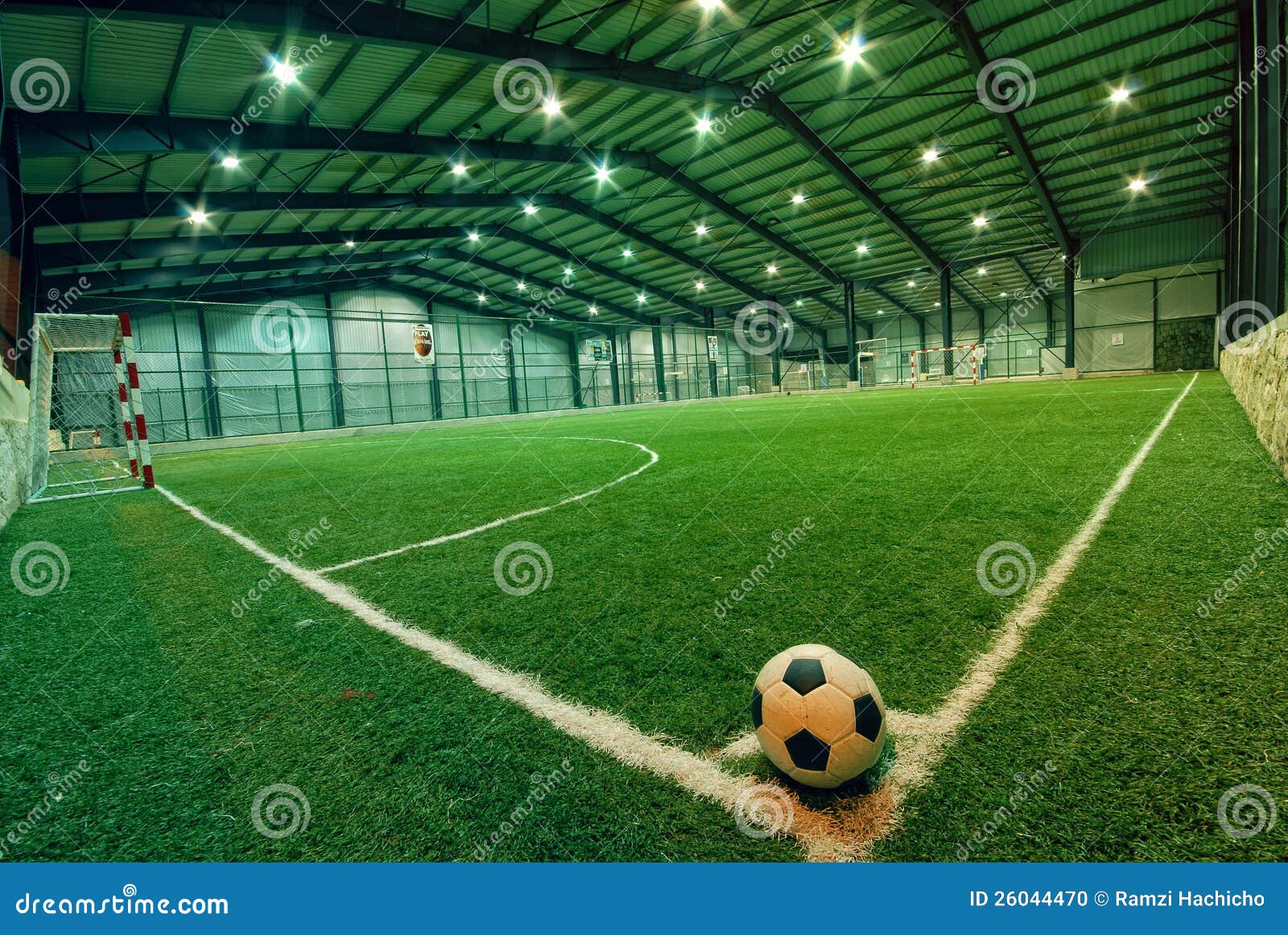 soccer ball on green grass in an indoor playground