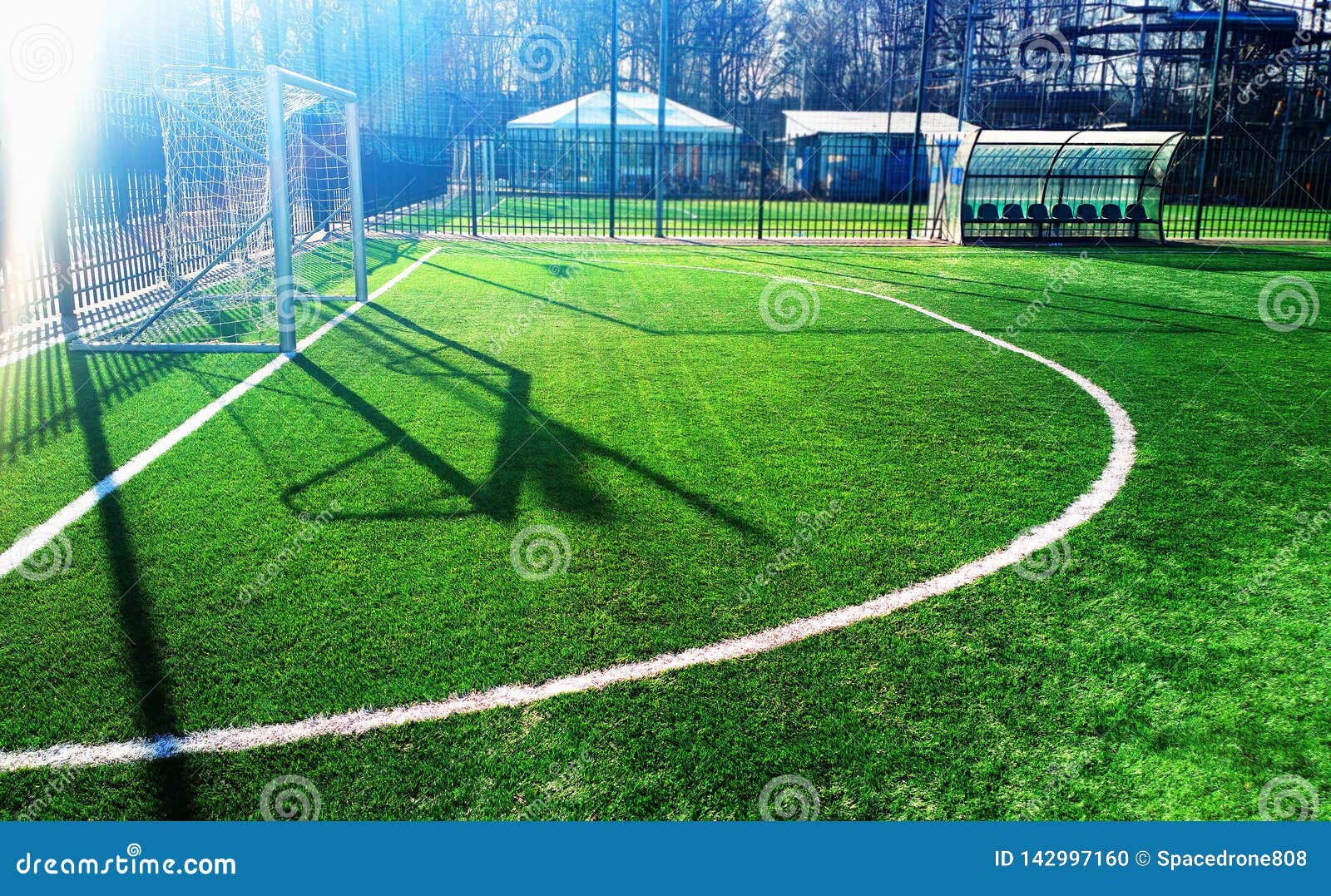 Soccer Goal on Green Field with Dramatic Shadows Background Stock Photo