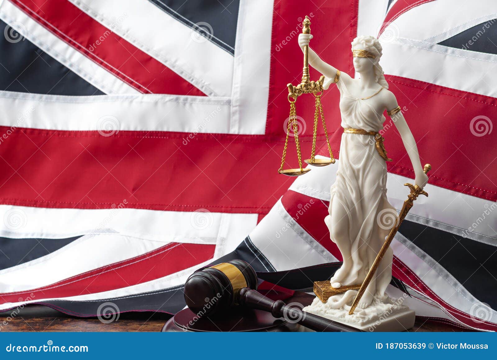social contract and the rule of law in the united kingdom of great britain concept theme with statue of goddess justitia, wooden