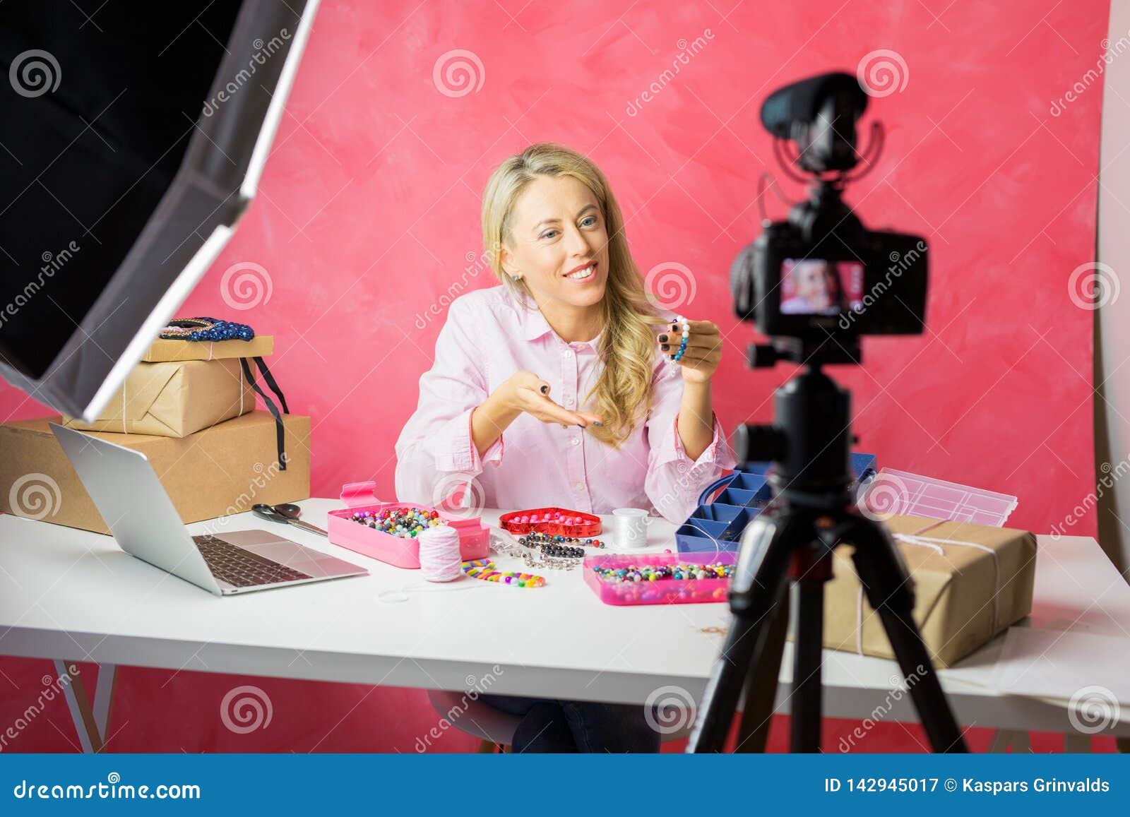 social media influencer young woman recording video blog with instructional how-to tutorial for making your own jewellery