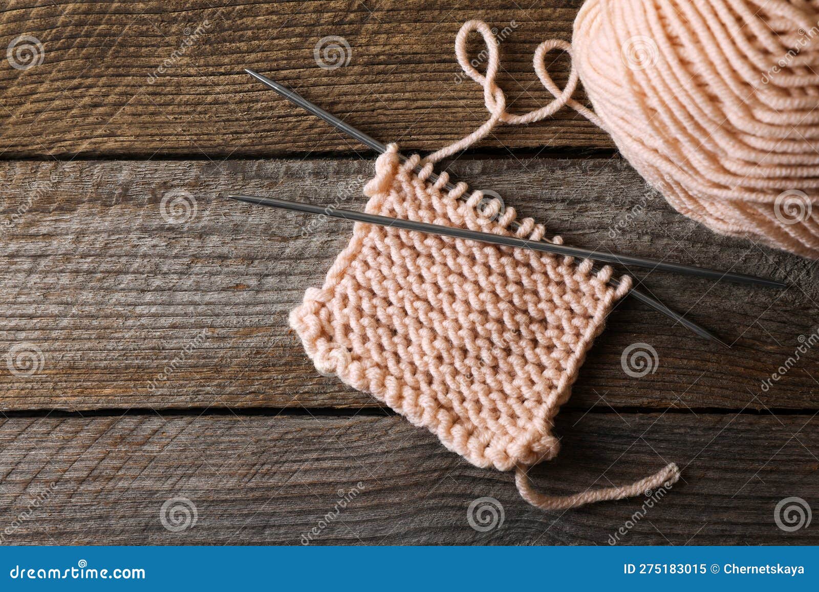 Soft Beige Yarn, Knitting and Metal Needles on Wooden Table, Flat Lay ...