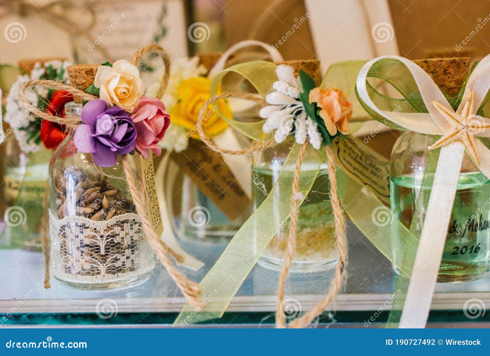 Soft Focus of Decorative Vials with Ribbons and Artificial Flowers for Event Souvenirs Stock