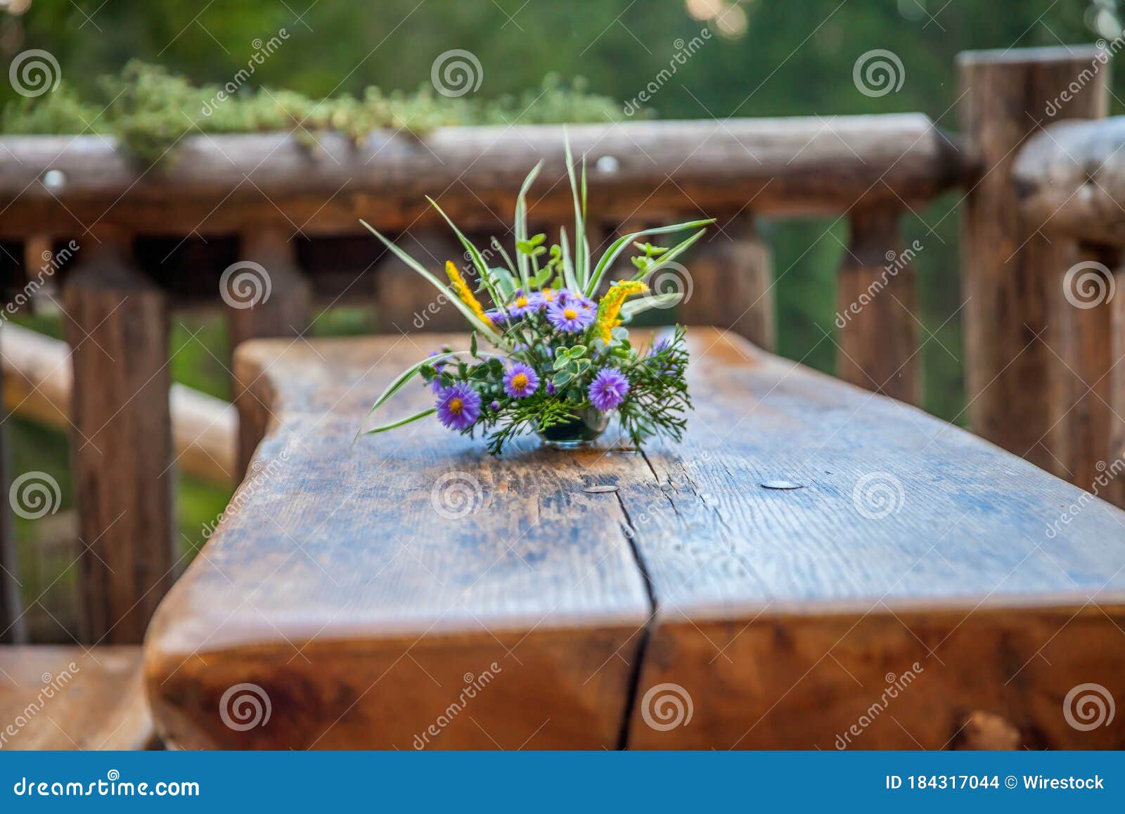 soft focus of a floral centerpiece on a wooden table at hija glamping lake bloke in slovenia