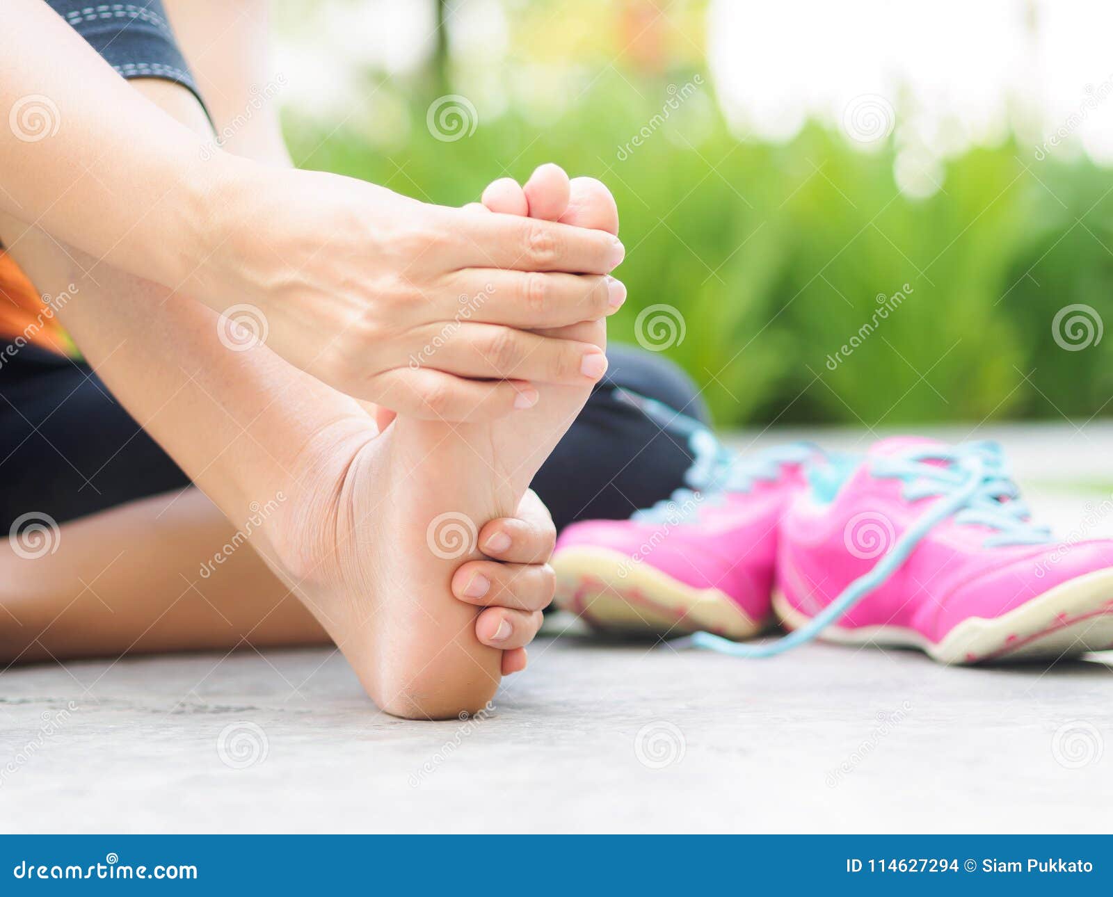 soft focus woman massaging her painful foot while exercising.