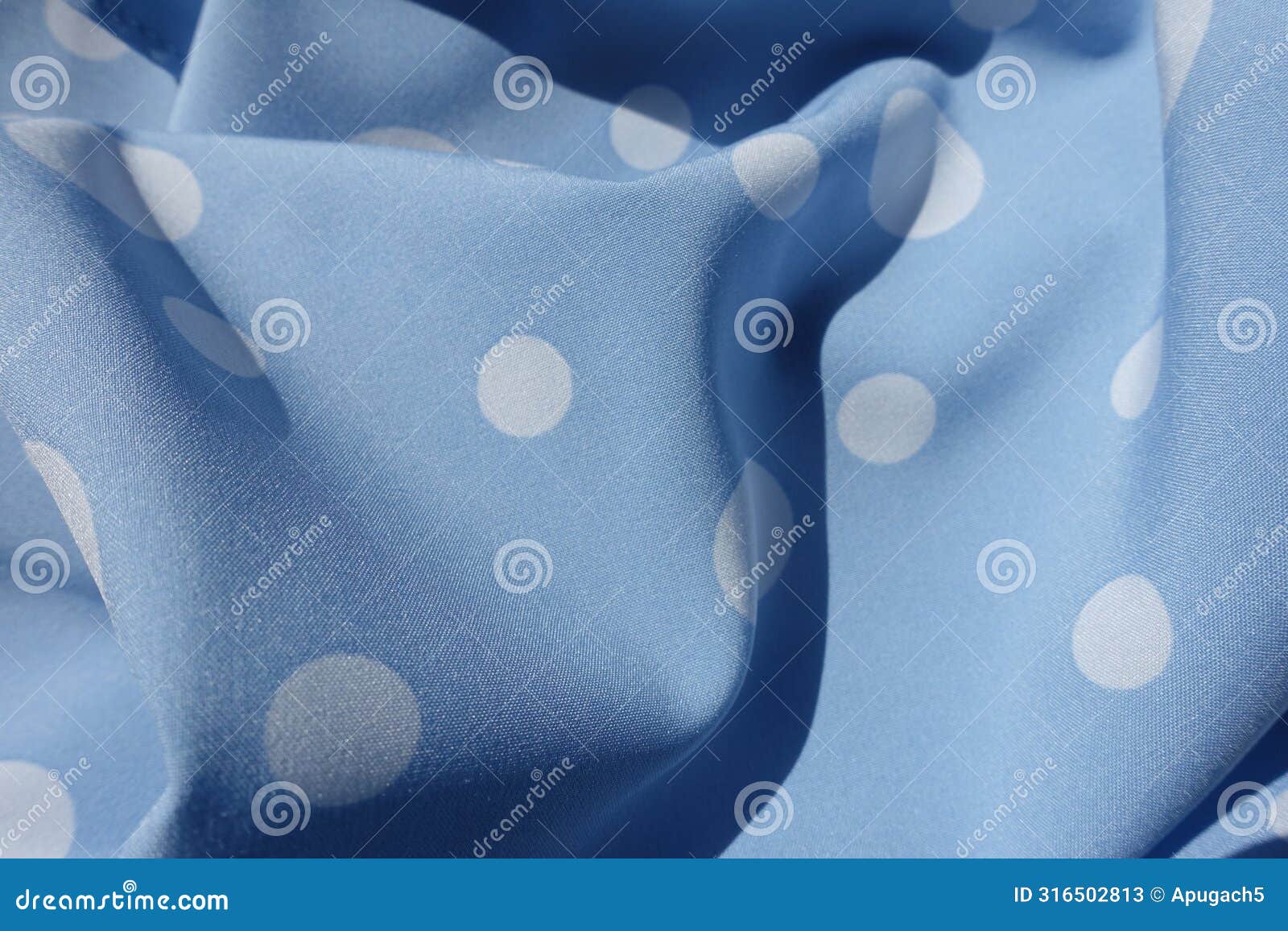 soft folds on blue rayon fabric with polka dot pattern