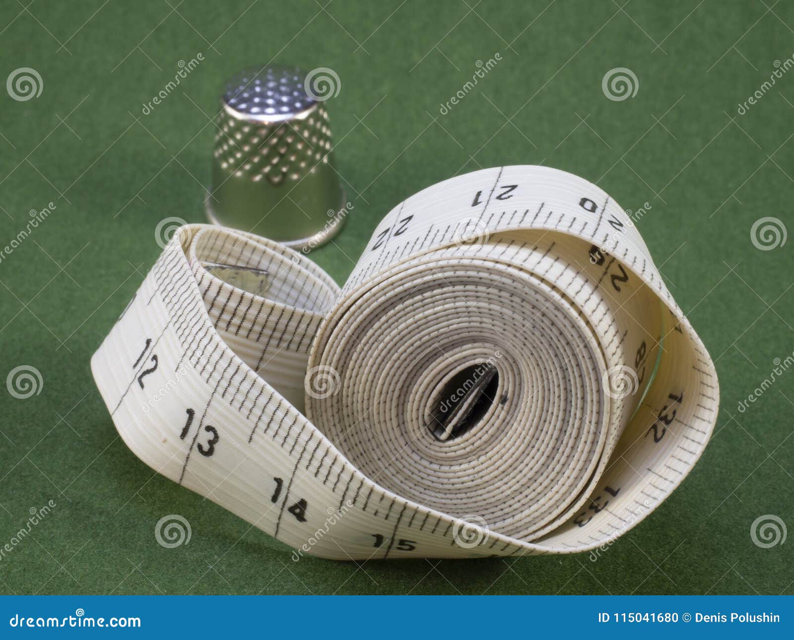Meter for Tailors and Thimbles Lie on a Green Background. Stock Photo