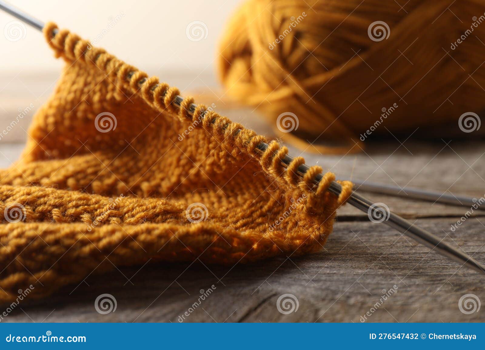 Soft Orange Knitting and Metal Needles on Wooden Table, Closeup Stock ...