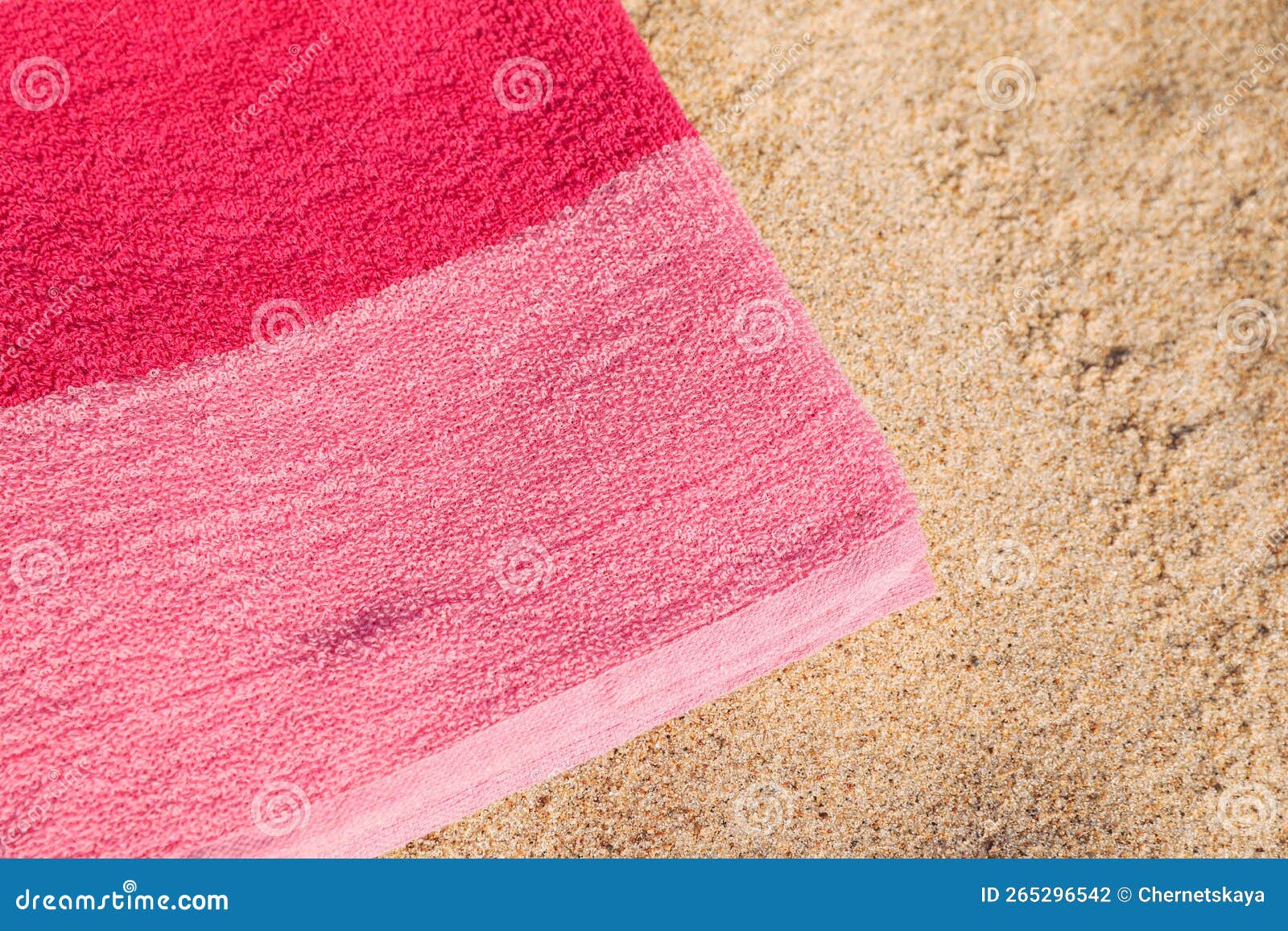 Soft Pink Beach Towel on Sand, Closeup. Space for Text Stock Photo