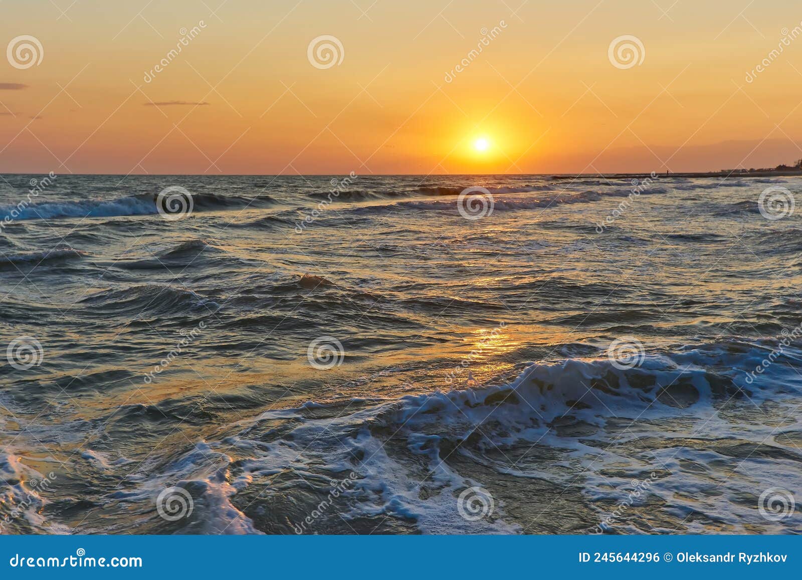 Soft Sea Waves and Bubbles on the Beach with Sunset Sky Stock Photo