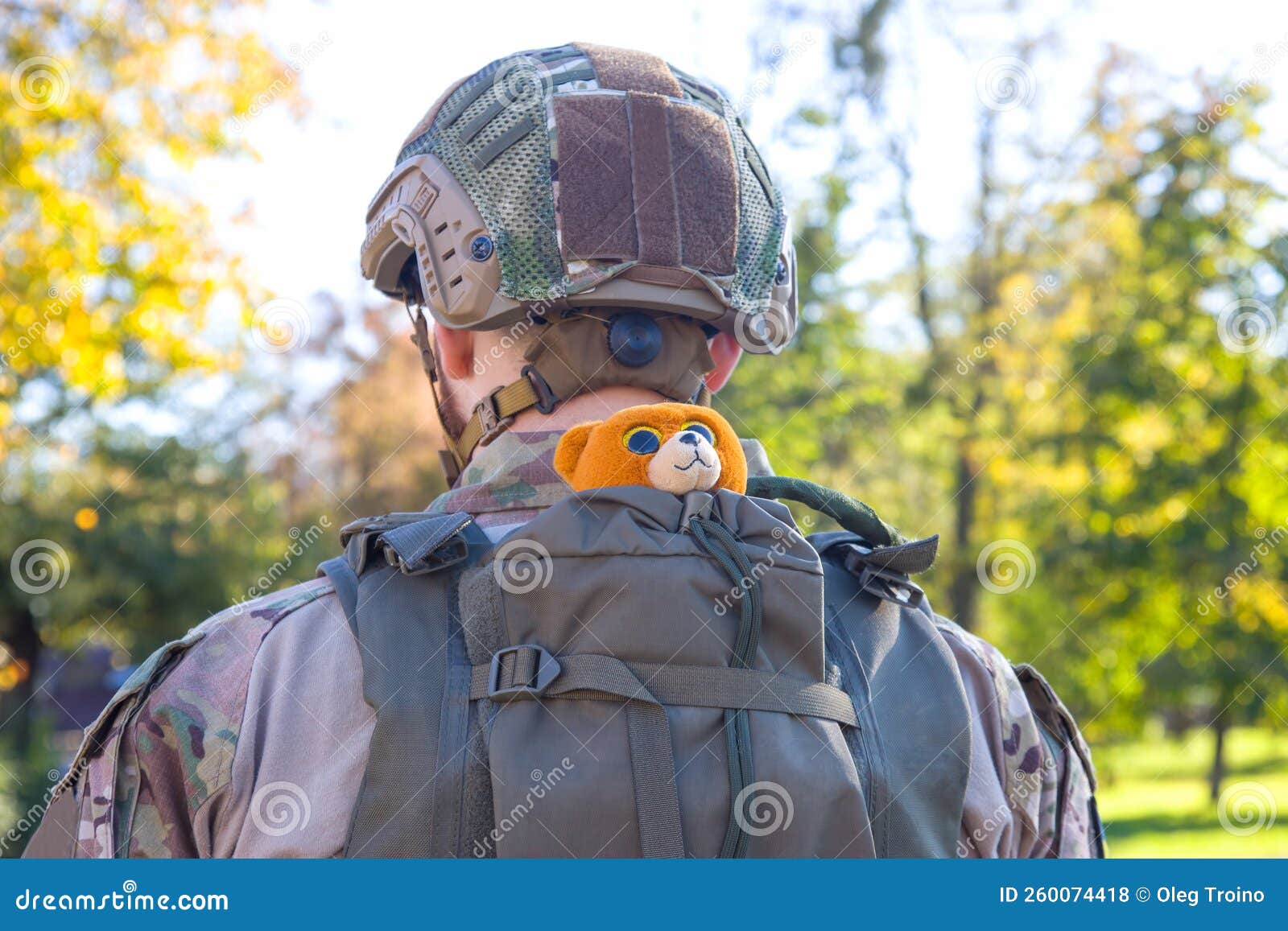 Soft Toy in a Backpack on the Back of a Soldier of Ukraine Stock Photo