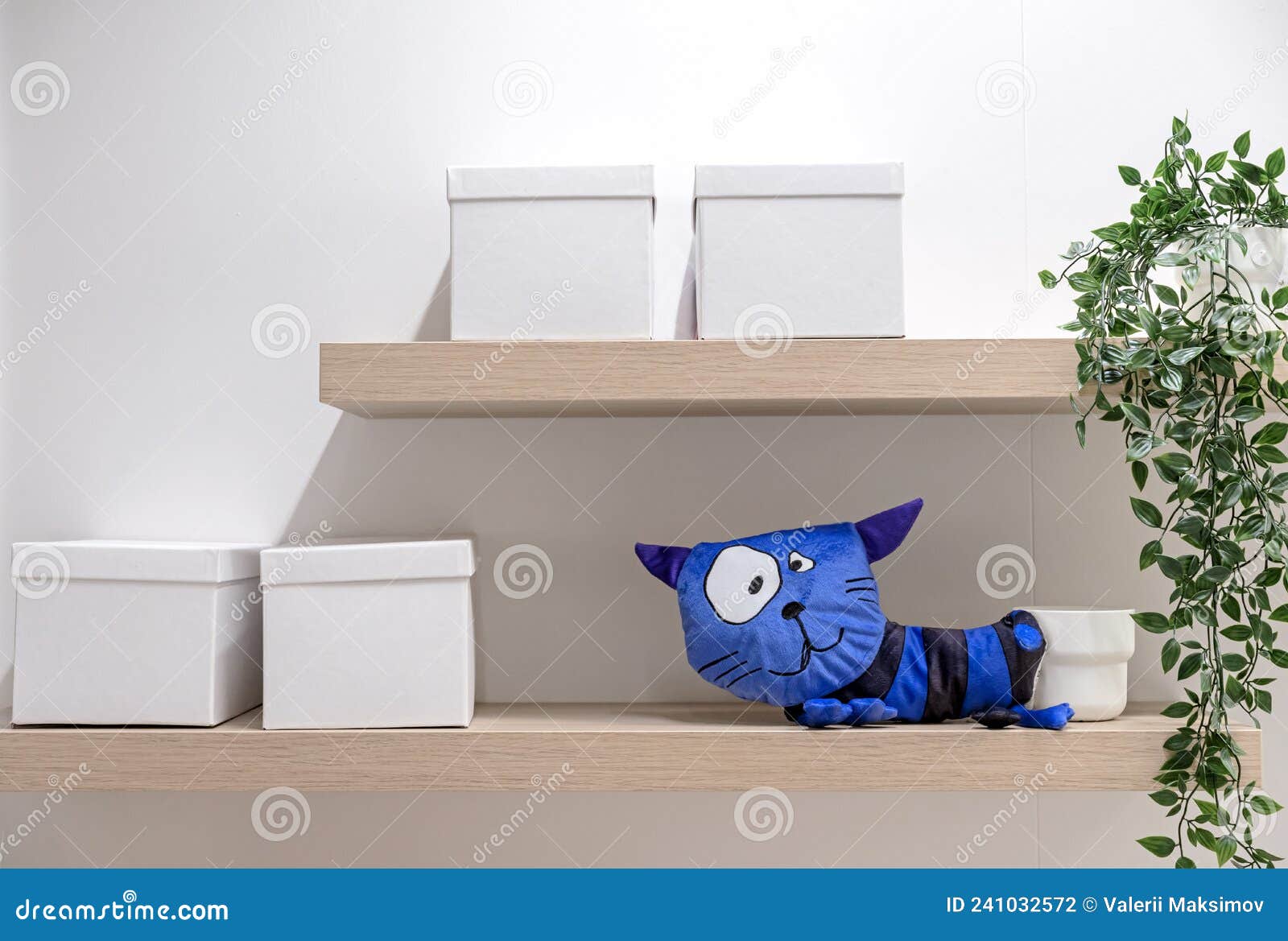 Soft Toy Blue Cat and Storage Boxes on a Wooden Shelf Stock Photo