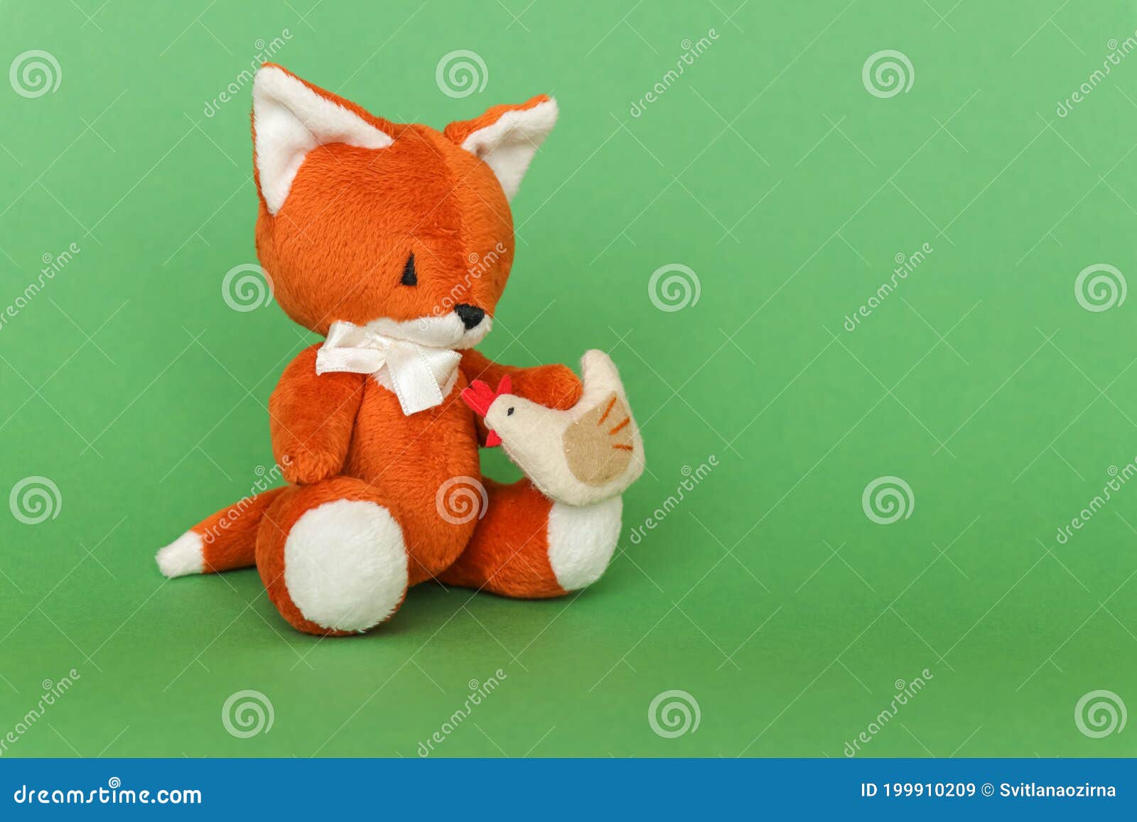 Soft Toy Ginger Fox with Chicken on a Green Background Stock Image