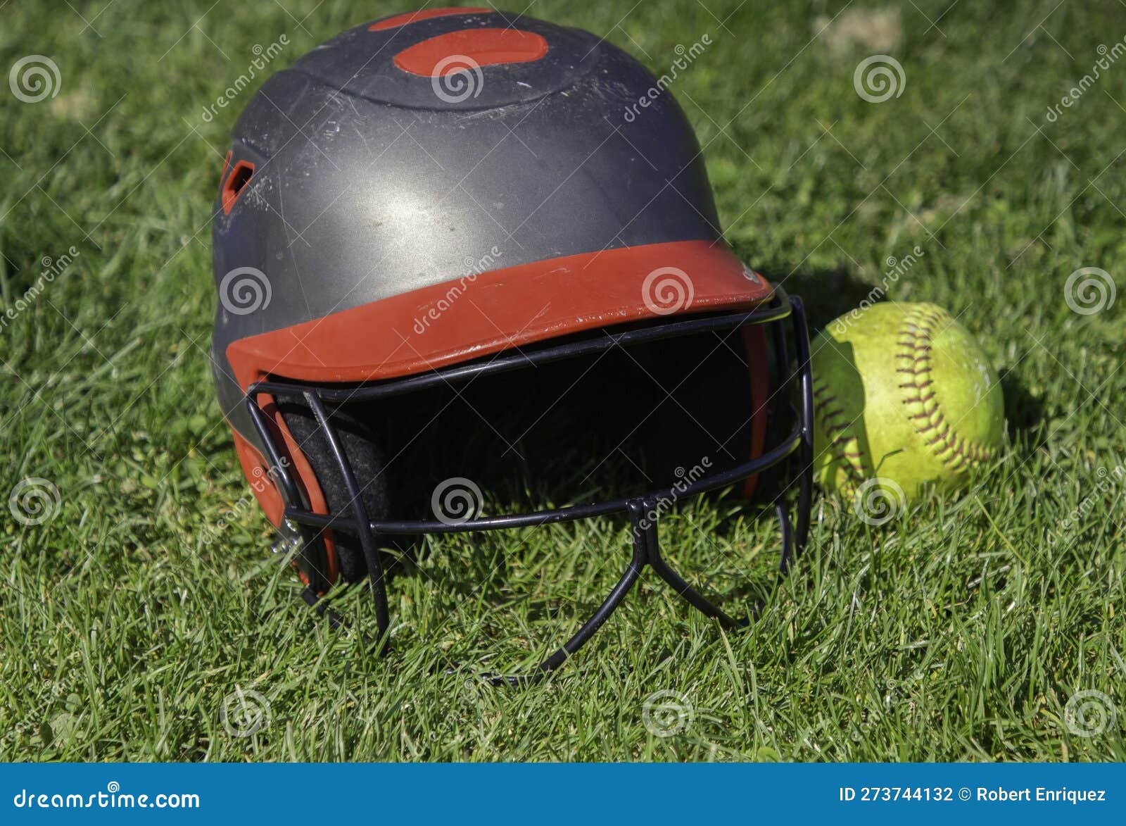 A Softball Helmet and Ball in the Grass Stock Photo Image of helmet