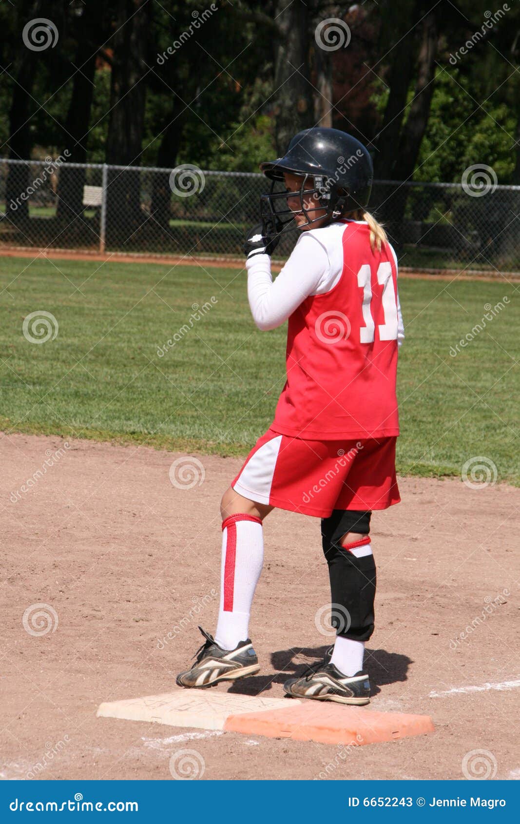 Softball player on base stock image. Image of focus, grass 6652243