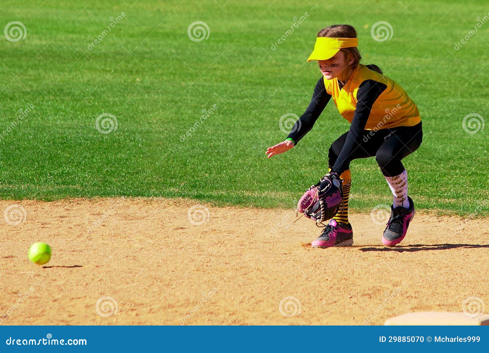 softball player fielding a ground ball