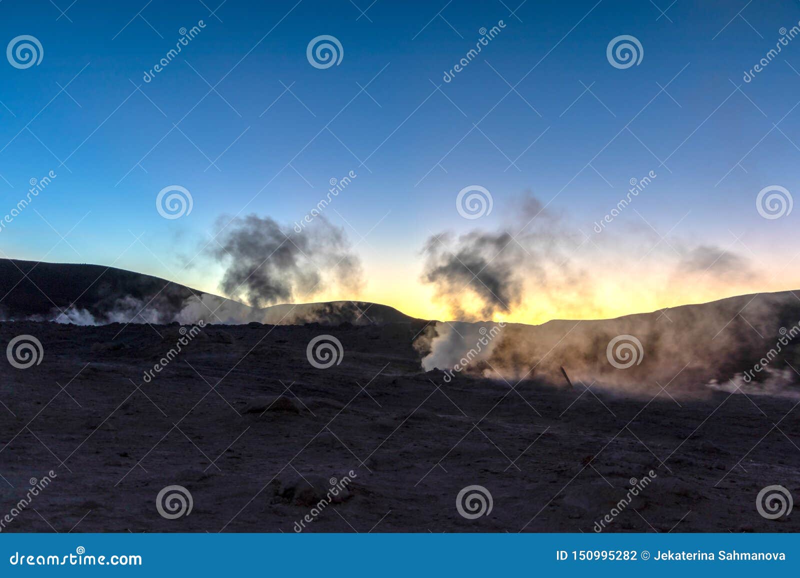 the sol de la manana, rising sun steaming geyser field high up in a massive crater in bolivian altiplano, bolivia