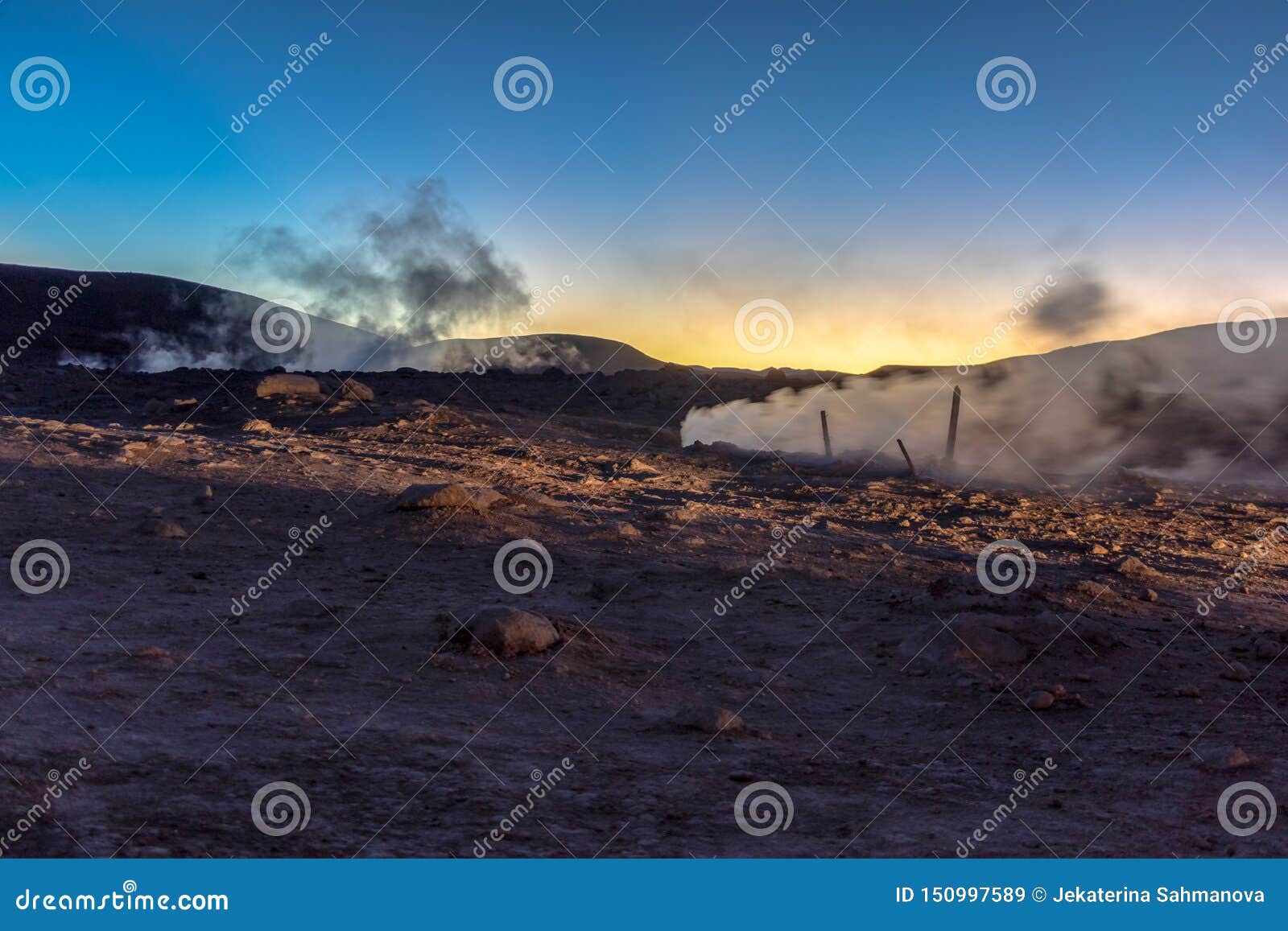 the sol de la manana, rising sun steaming geyser field high up in a massive crater in bolivian altiplano, bolivia