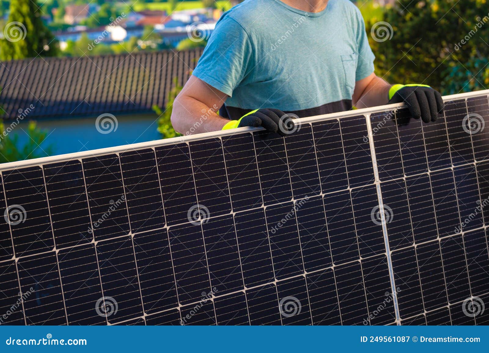Solar Panel in the Hands of a Worker in a Summer Garden. Fitting and
