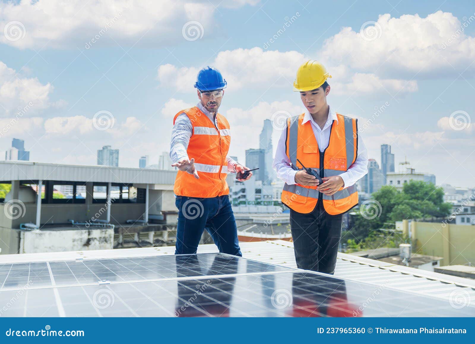 Solar Panel Technician on Roof. Engineer and Young Technician