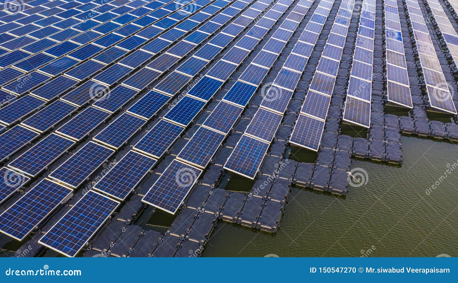 solar panels in aerial view, rows array of polycrystalline silicon solar cells or photovoltaics in solar power plant floating on