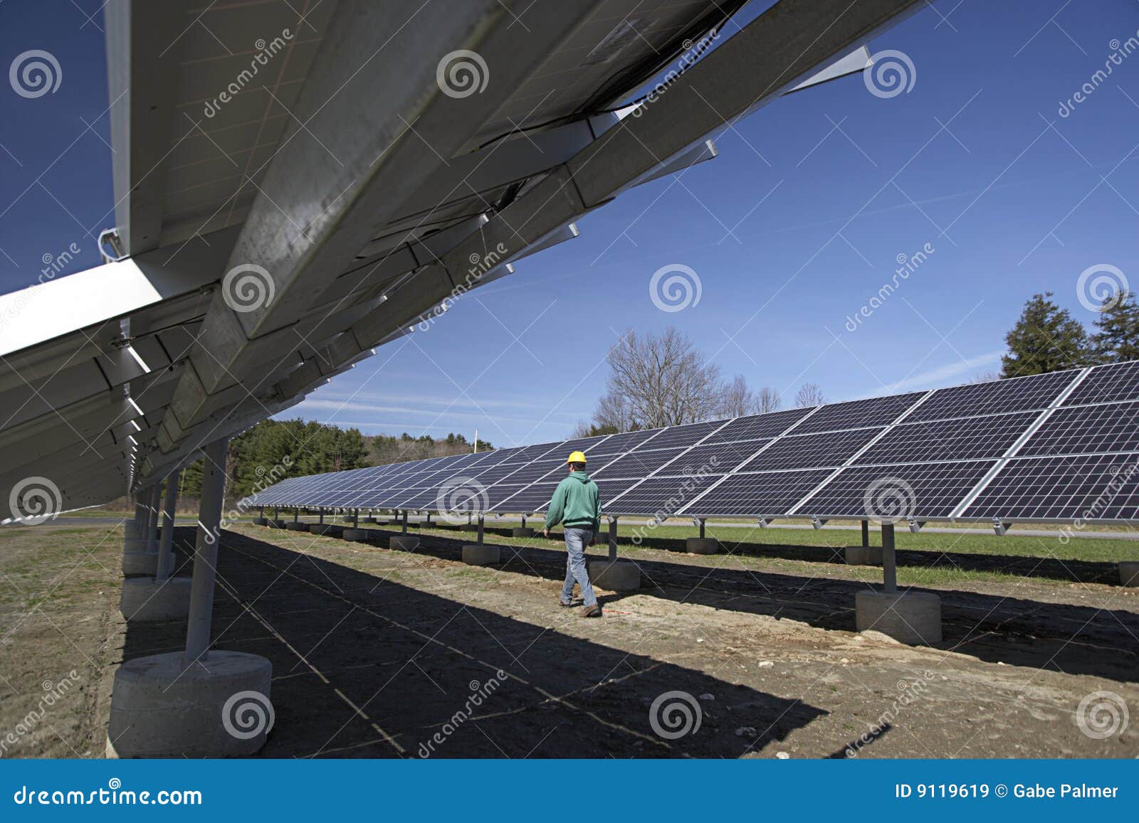 solar panels inspected by workman