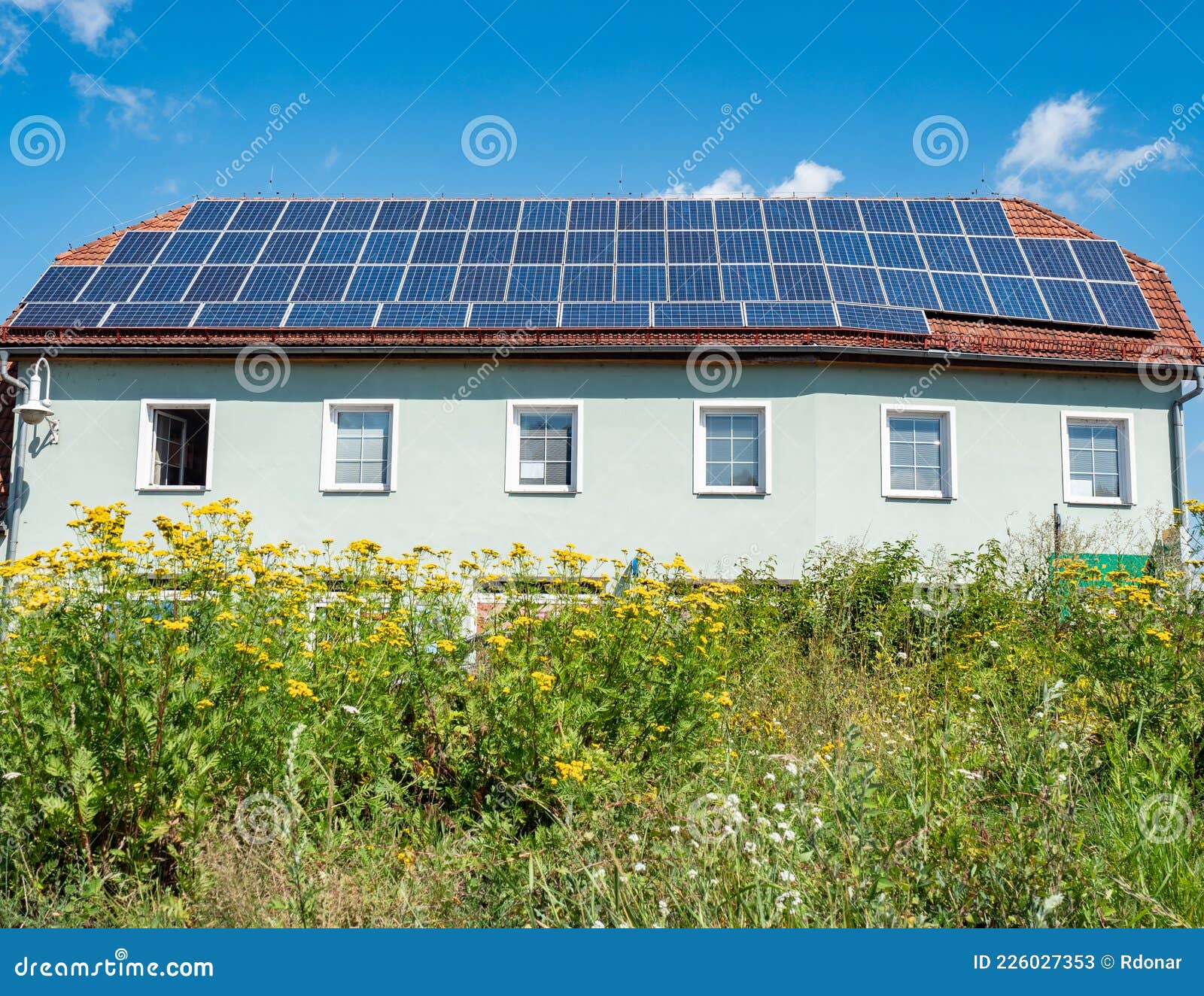 solar panels installed on the red tiled roof of a house  europe