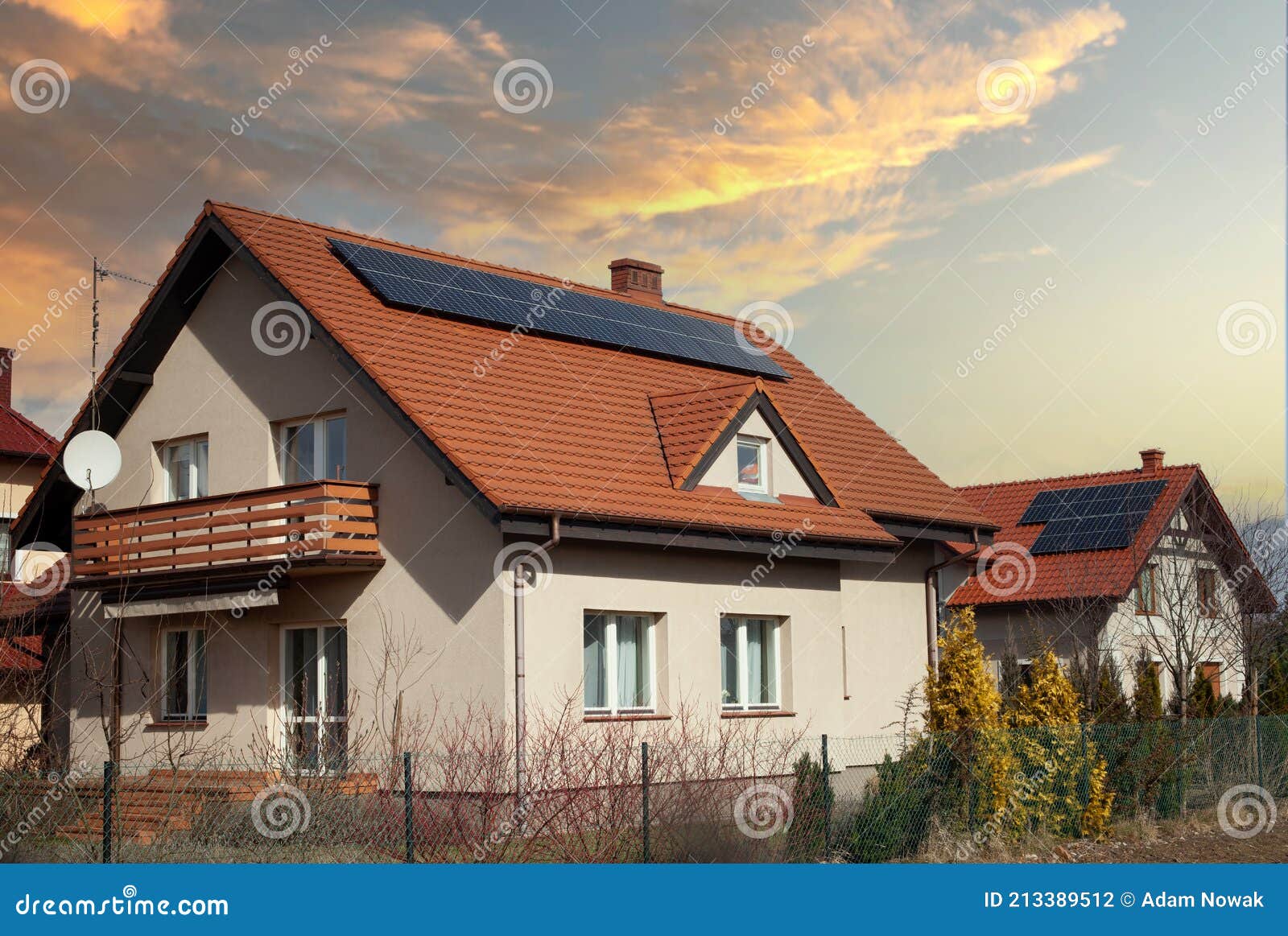 solar panels red roof of house - sunset