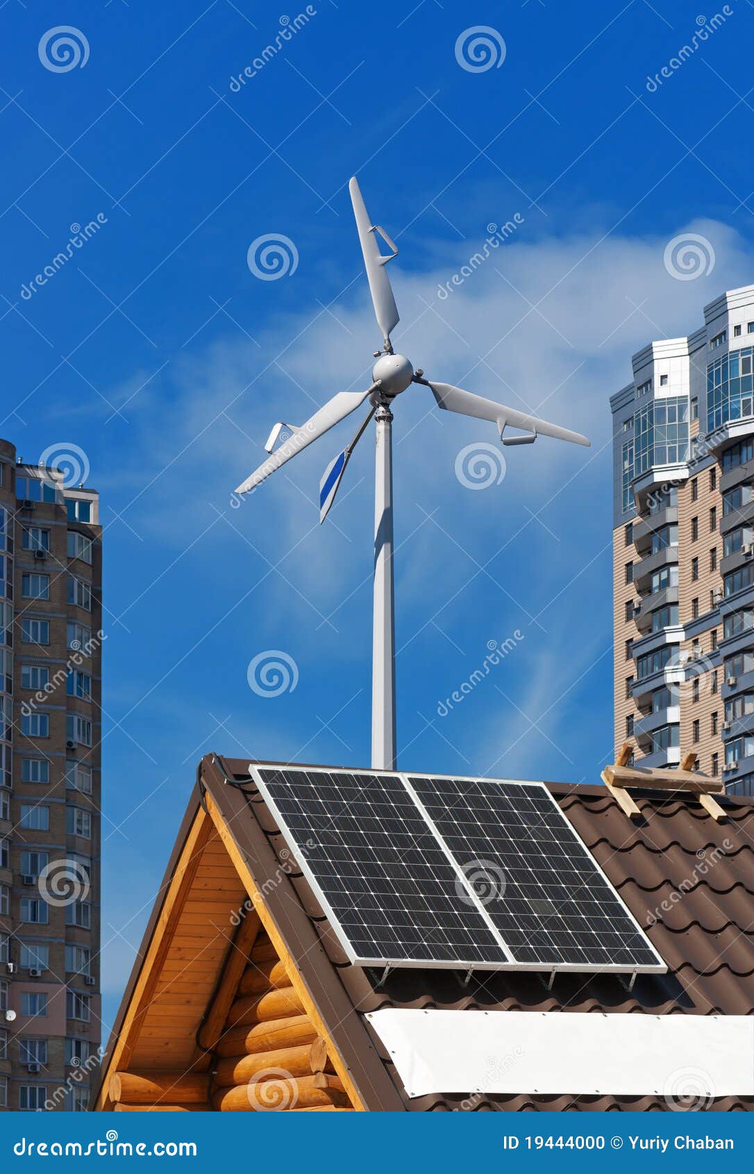 Solar and Wind Energy Generators on Wooden House. Stock Photo Image