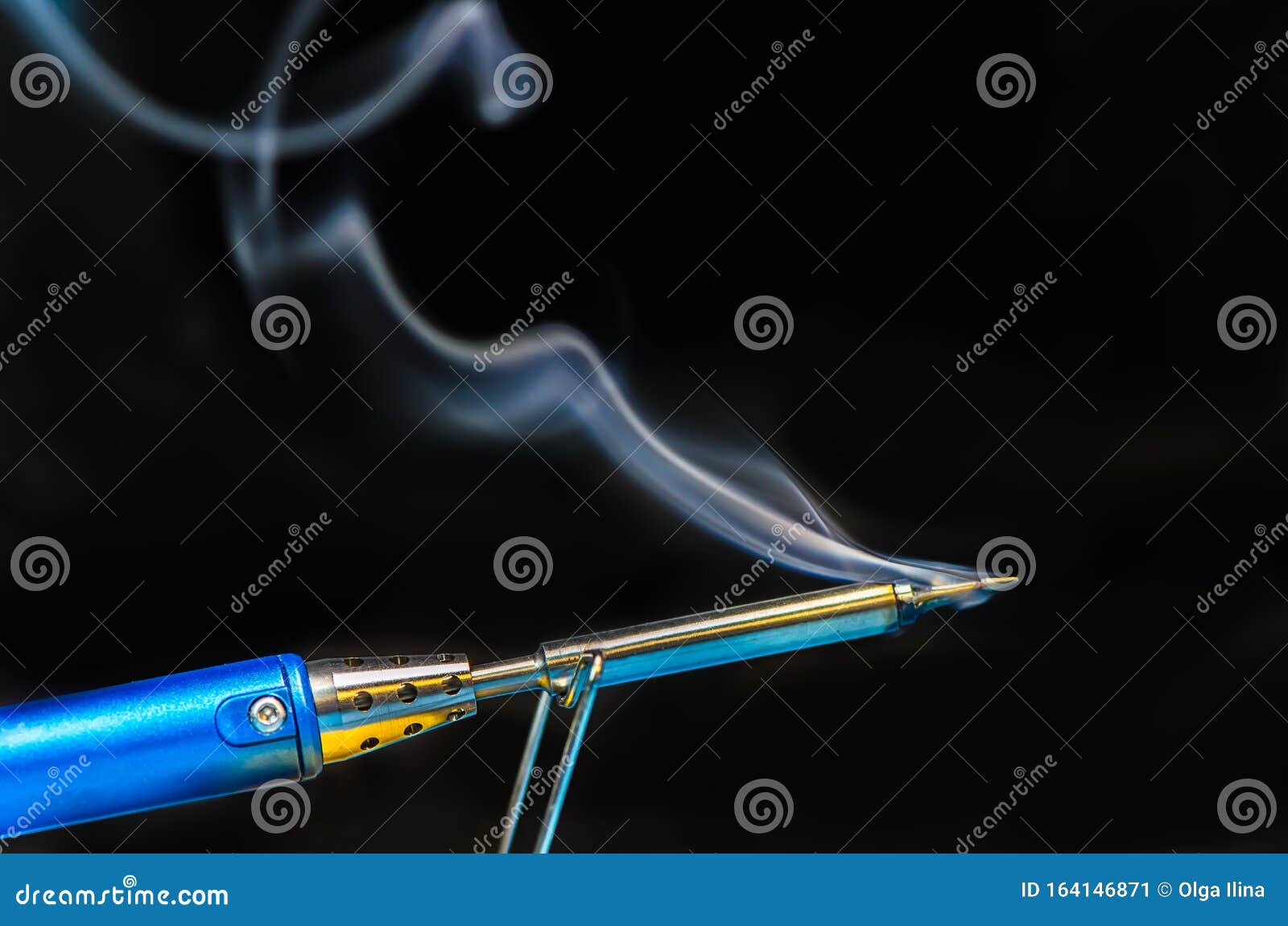 Soldering Iron with Smoke on a Black Background. Electrical Stock Image