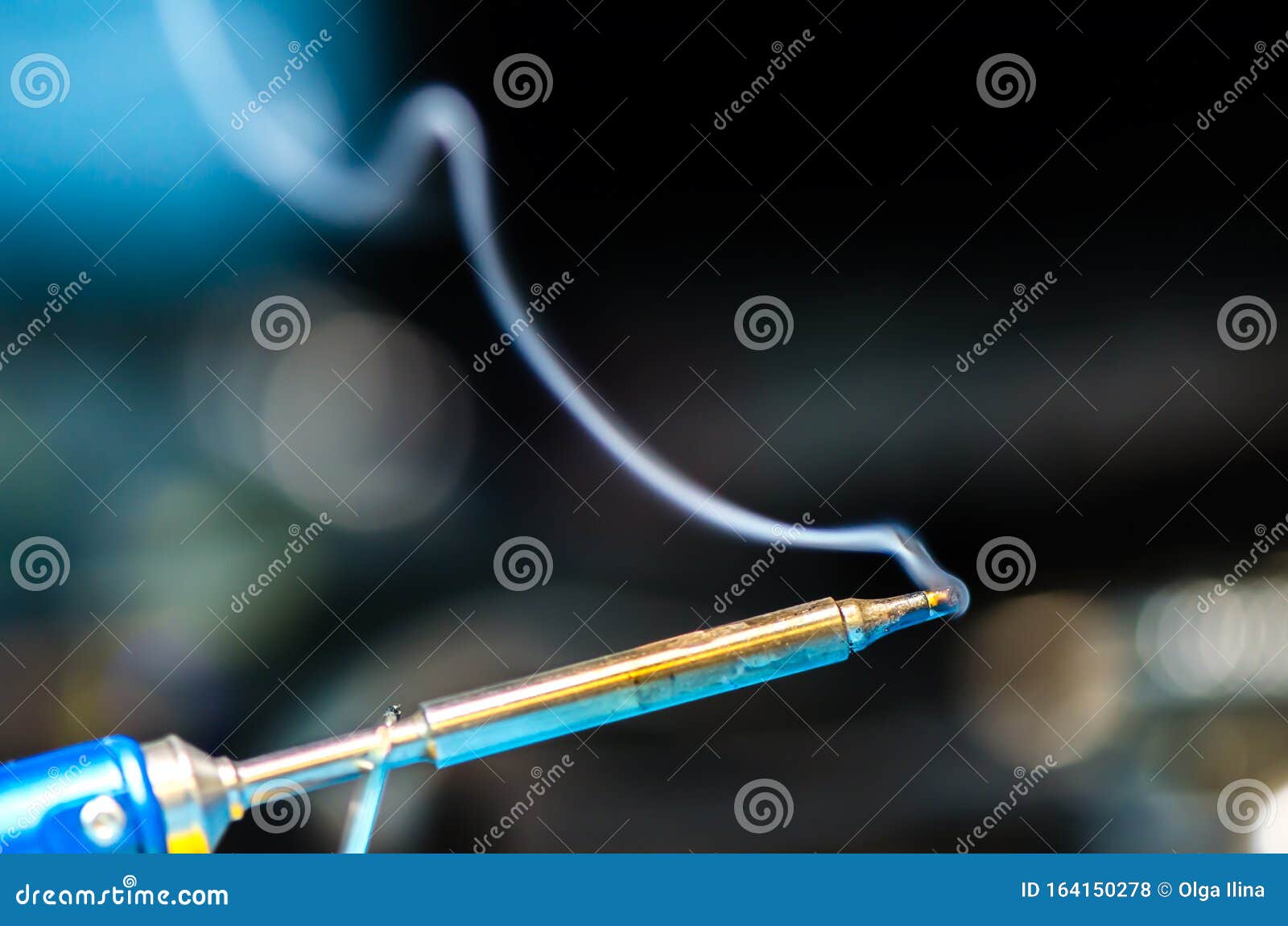 Soldering Iron with Smoke on a Black Background. Electrical Stock Photo