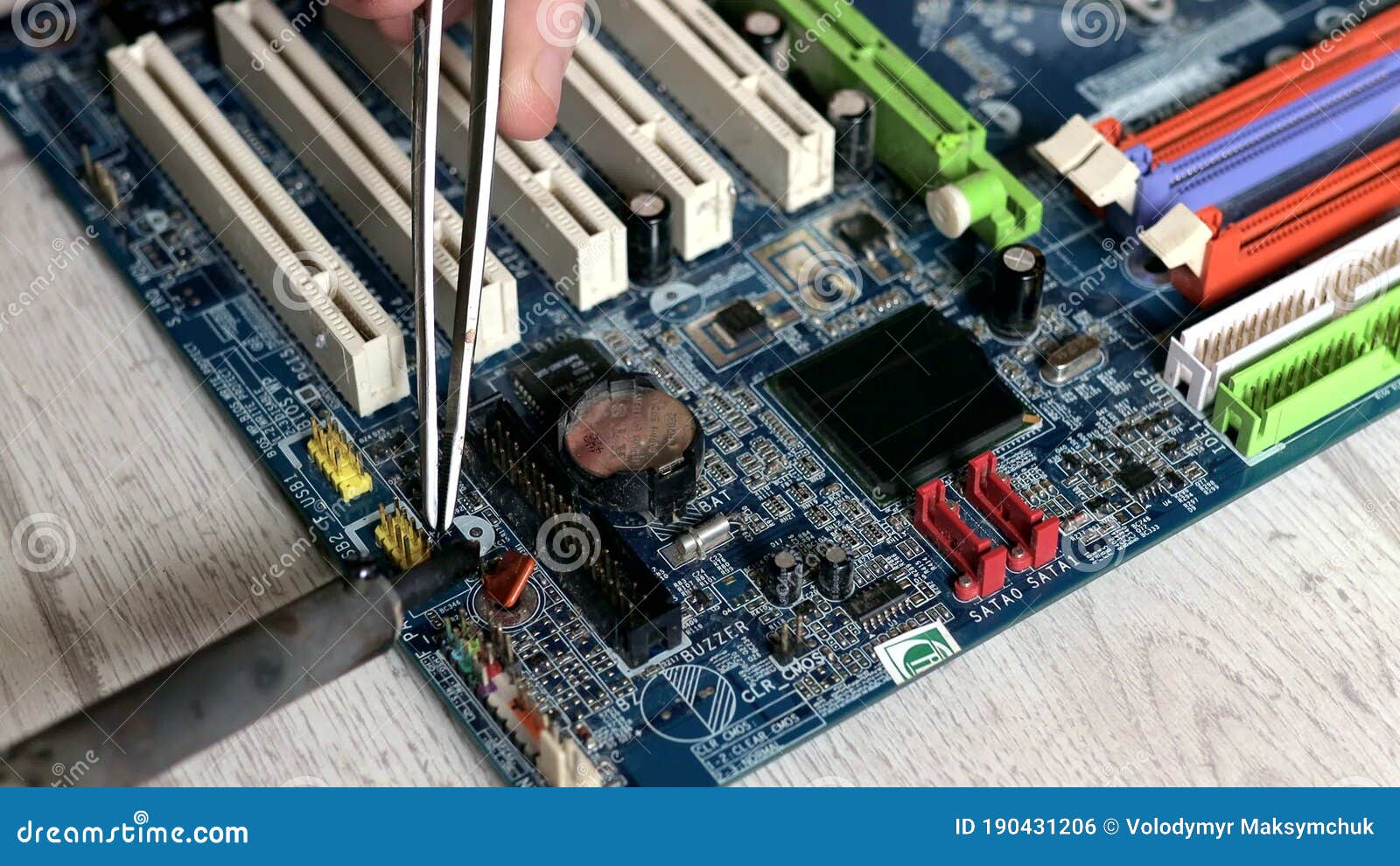 Soldering Motherboard. Engineer Solder a Chipset Under a Magnifying
