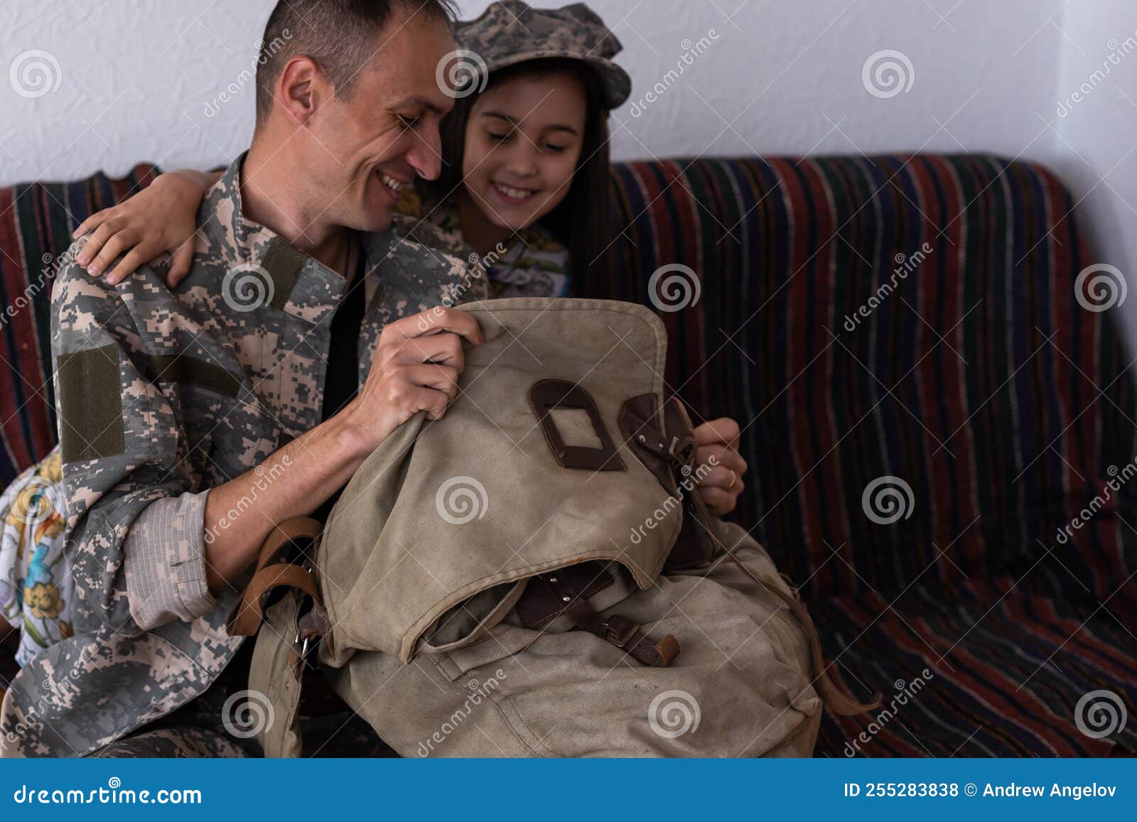 Soldier in Camouflage Playing with His Daughter at Home Stock Photo