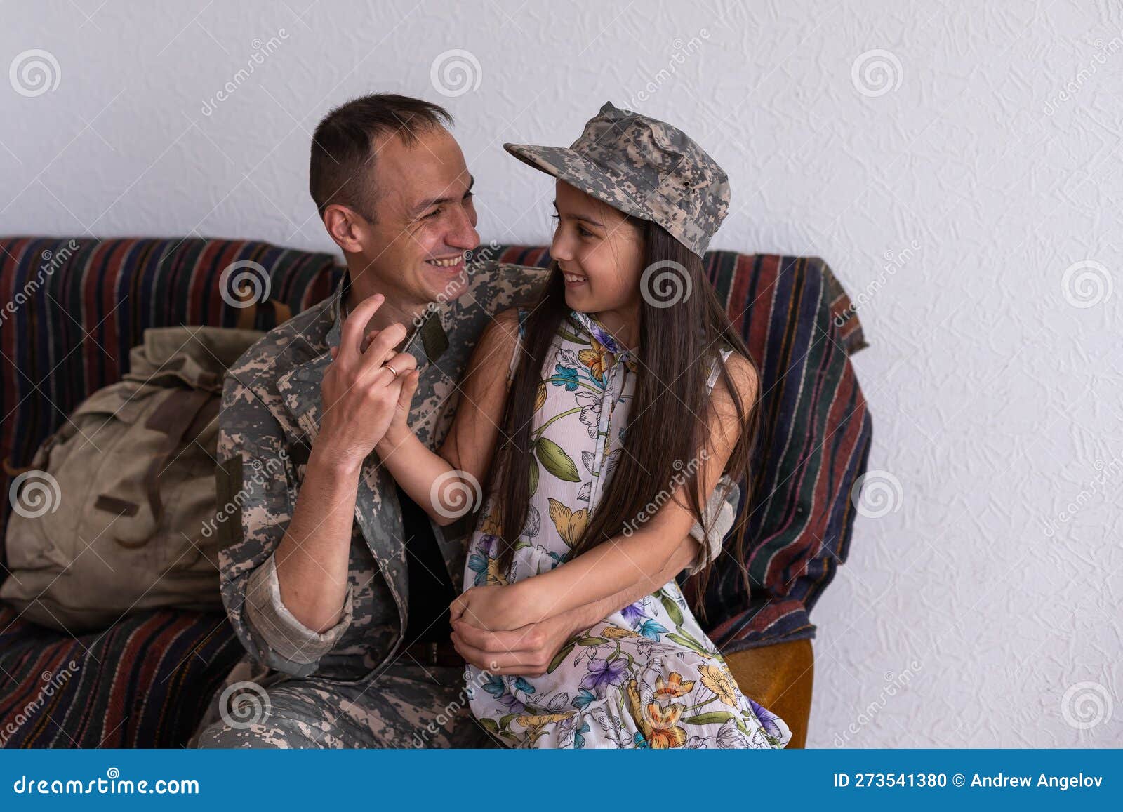 Soldier in Camouflage Playing with His Daughter at Home Stock Photo