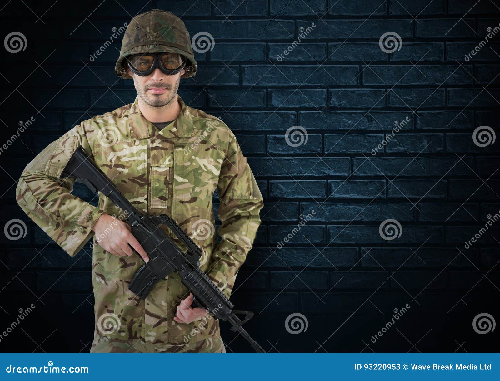 Soldier with Helmet, Glasses and Weapon. Dark Bricks Background Stock