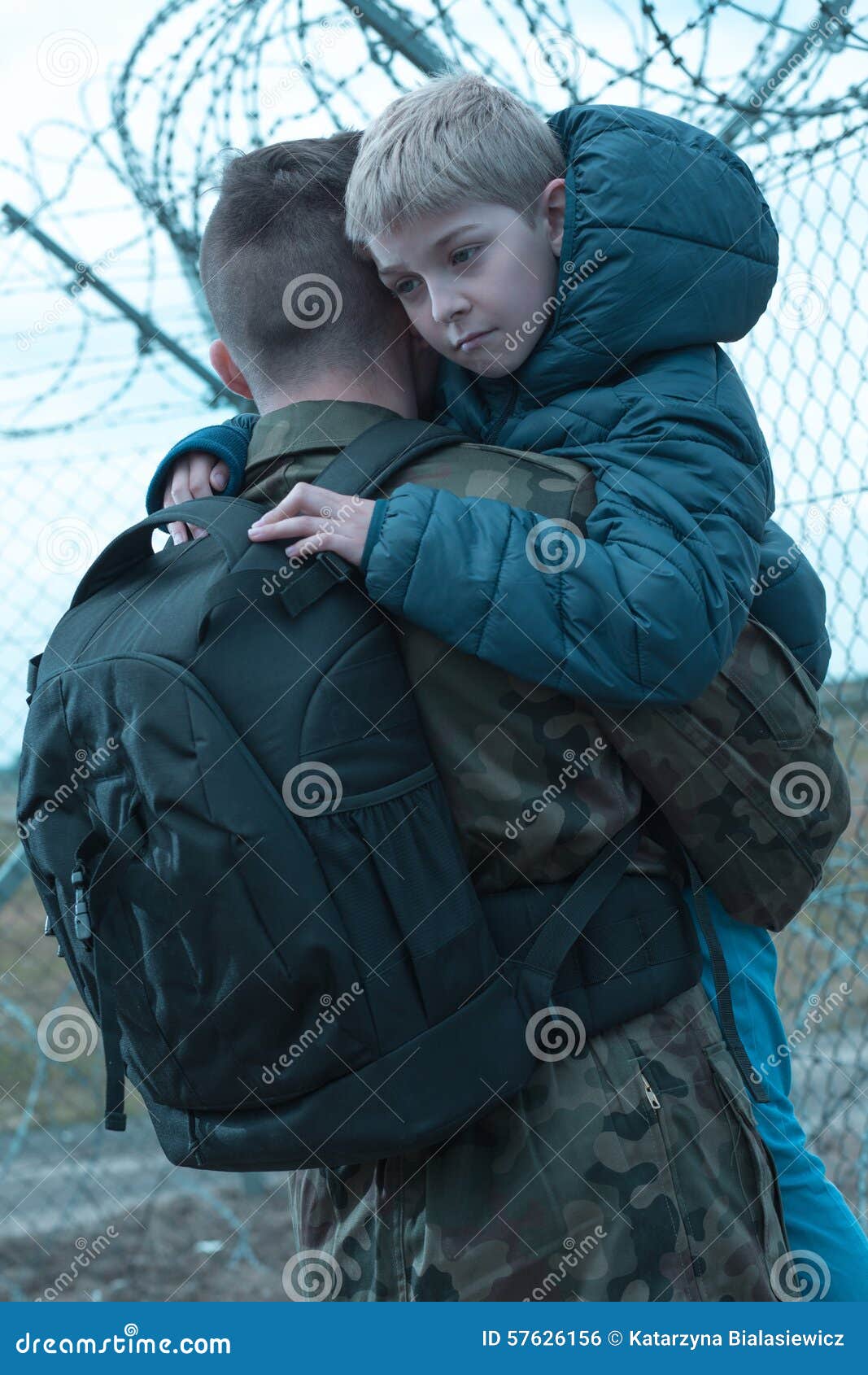 Soldier hugging little son stock photo. Image of backpack 57626156