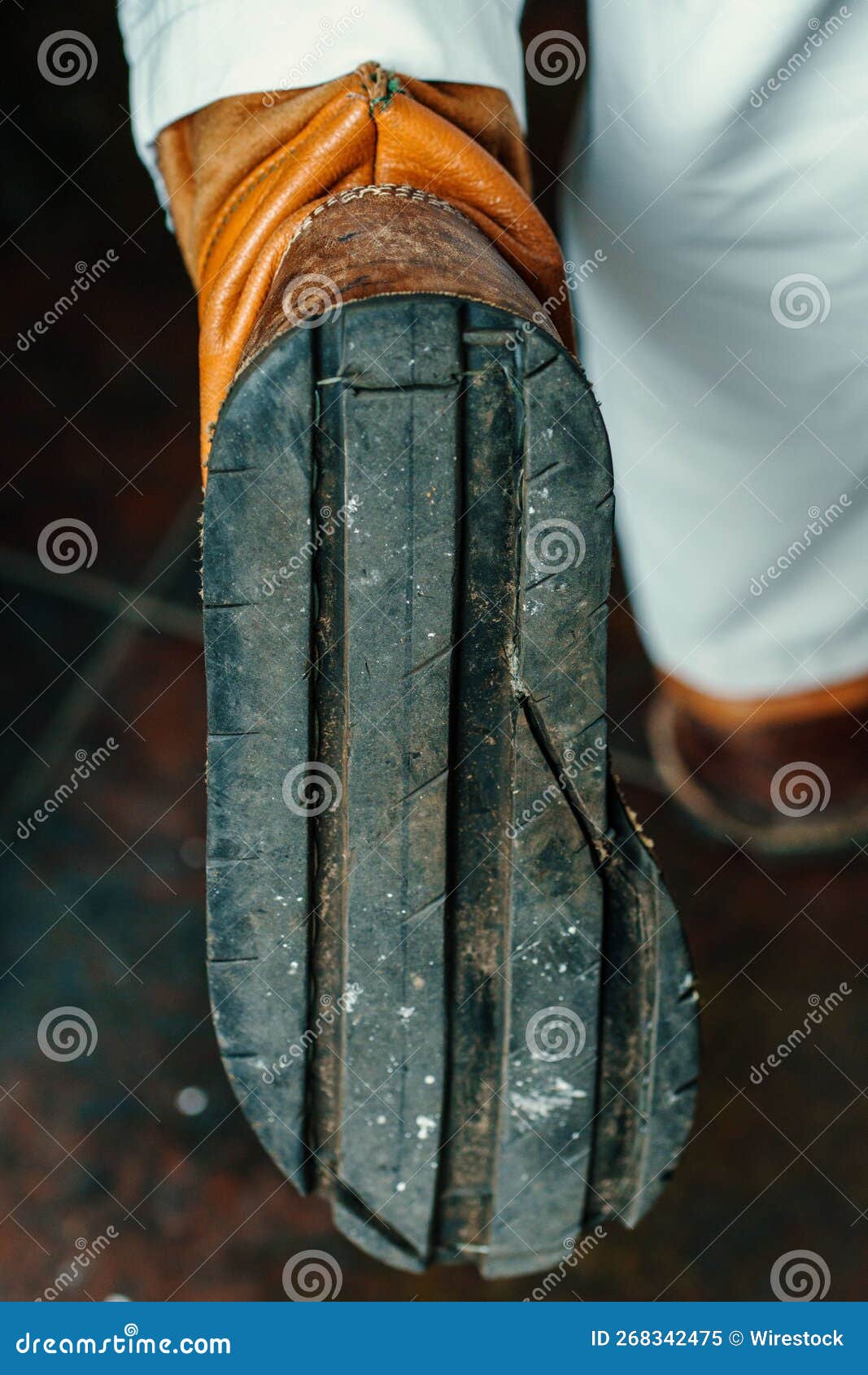 Sole of an Old Worn Yellow Shoe of a Man in White Pants Stock Image