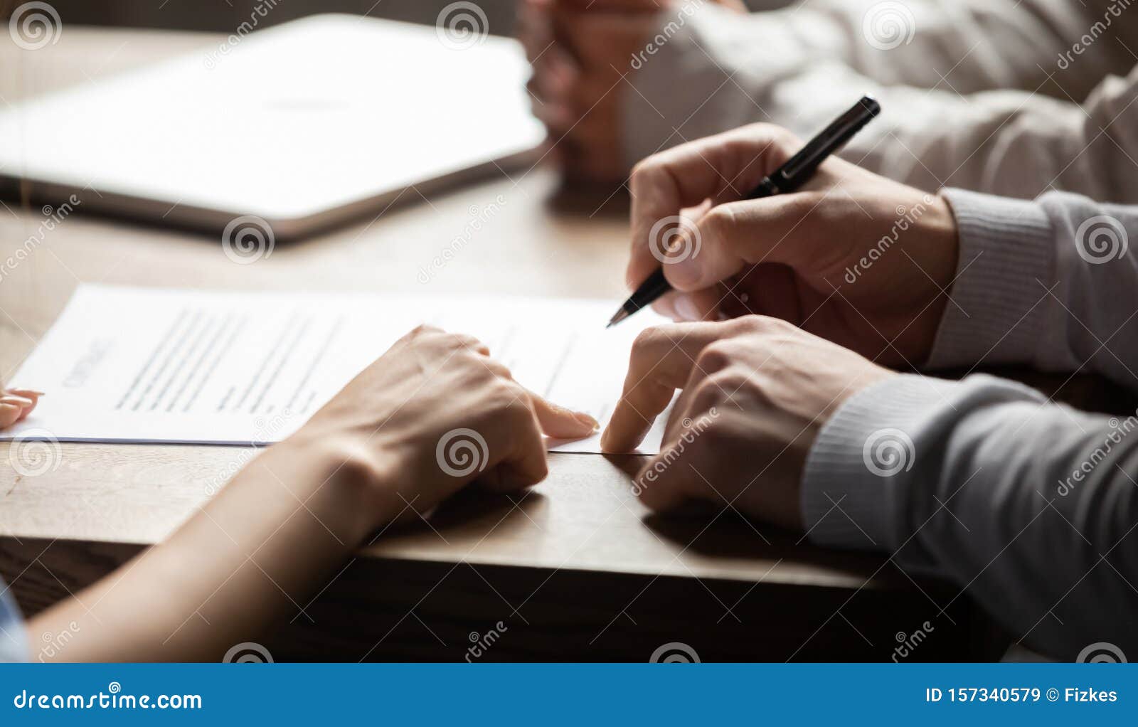 solicitor pointing at contract showing client where to write signature