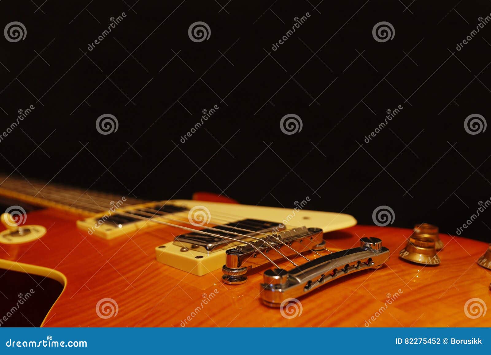 Solid Body Electric Jazz Guitar Closeup on Black Background, with
