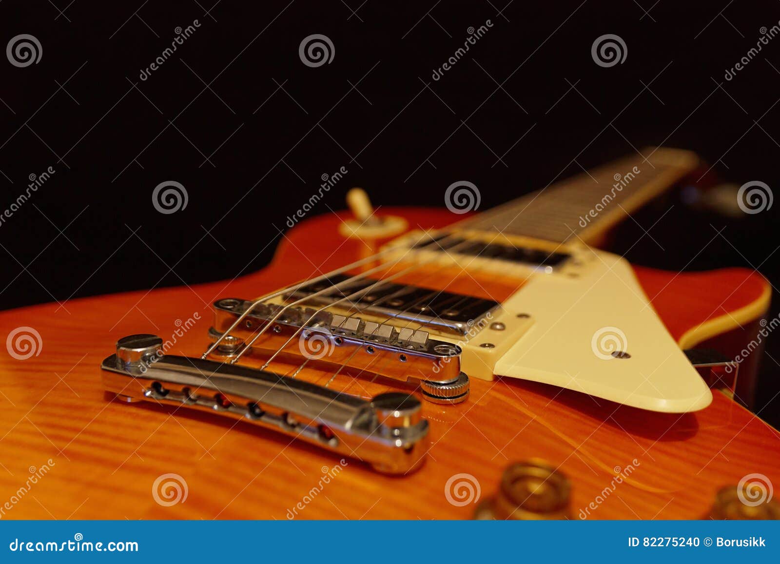 Solid Body Electric Jazz Guitar Closeup on Black Background. Selective