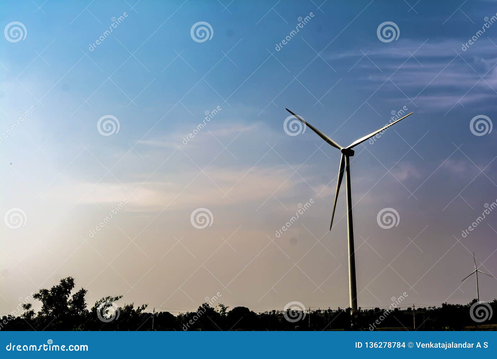 solitary wind turbine on blue sky background