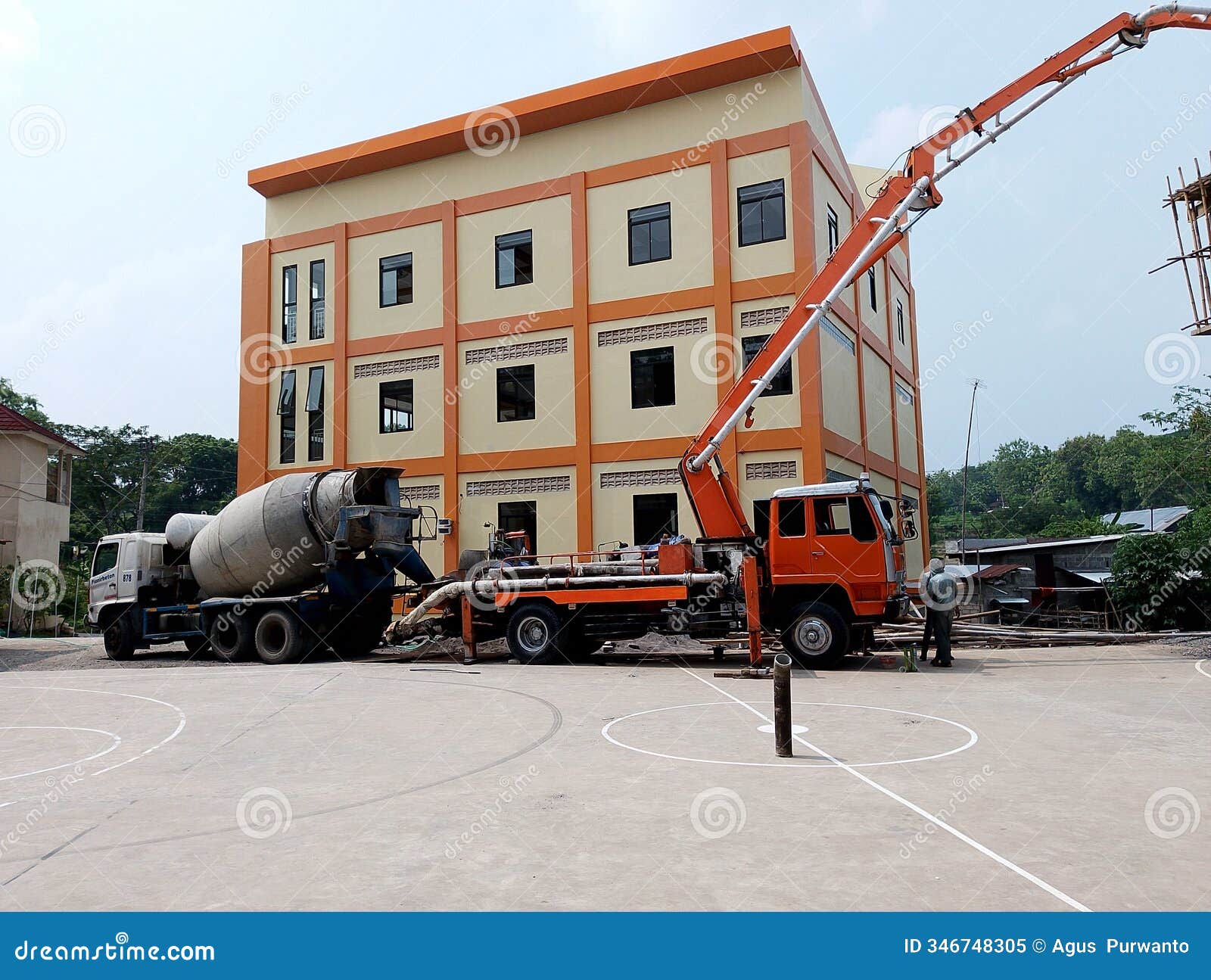 solo, central java, november 29, 2024: the process of constructing a multi-storey building using a concrete pump and mixer truck