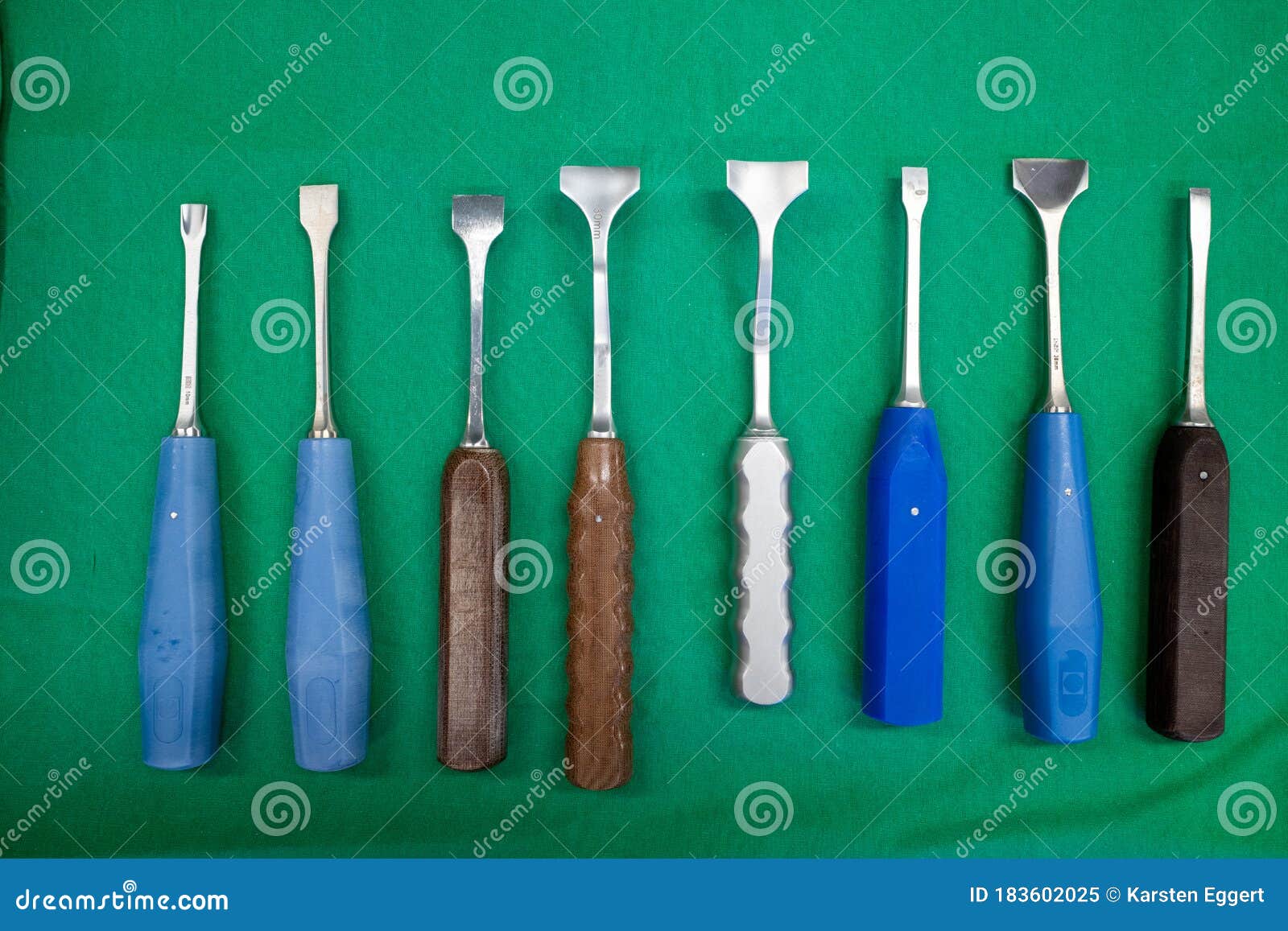 Some Different Surgical Chisels Lie Side by Side on a Surgical Drape