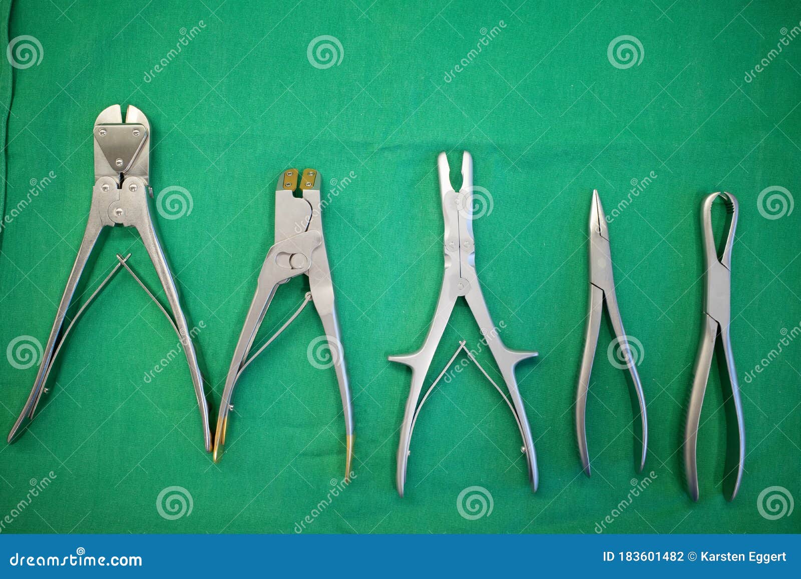 Some Different Surgical Pliers Lie Side by Side on a Surgical Drape