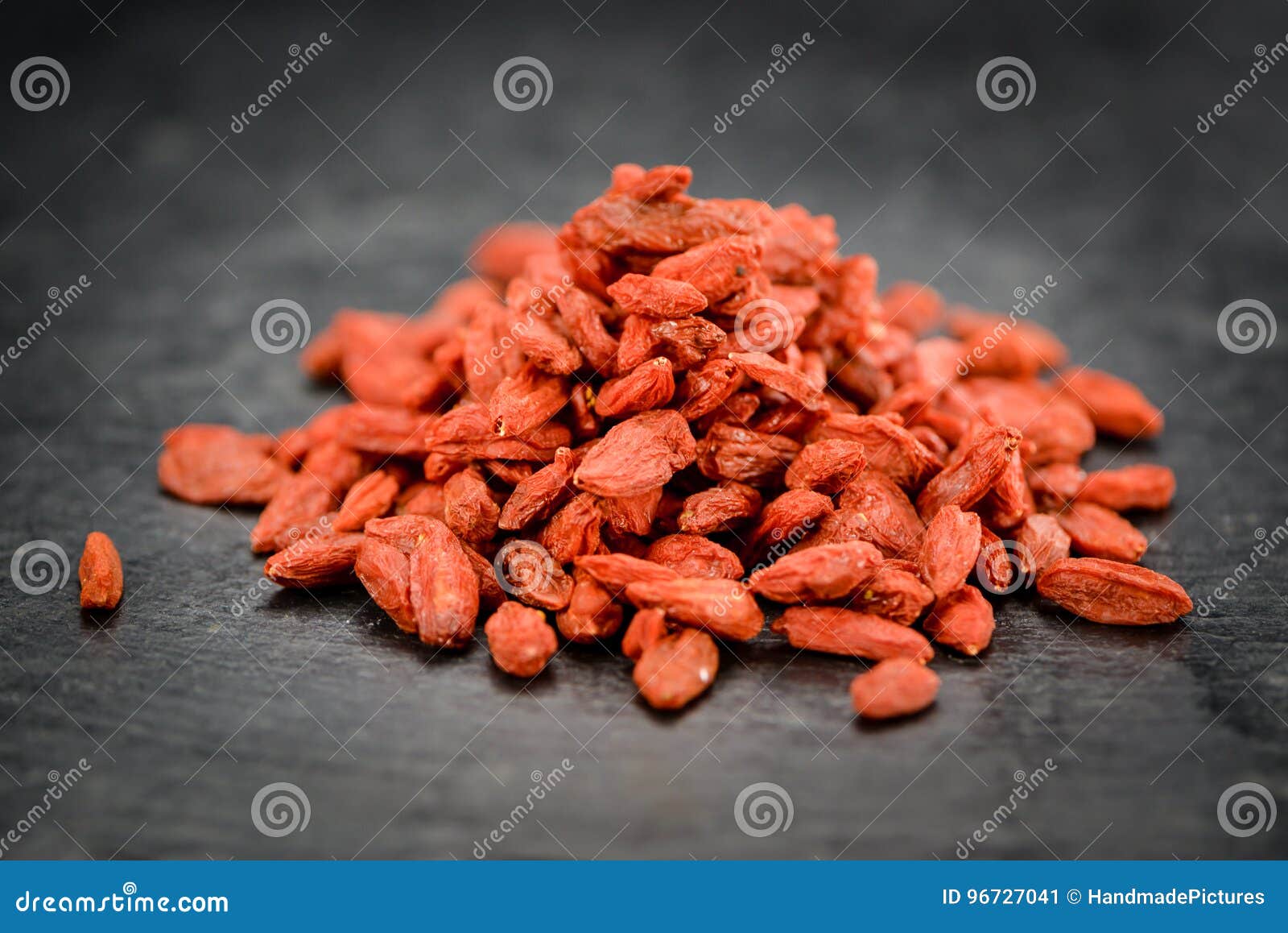 Some Goji Berries Dried on a Dark Slate Slab Stock Image Image of