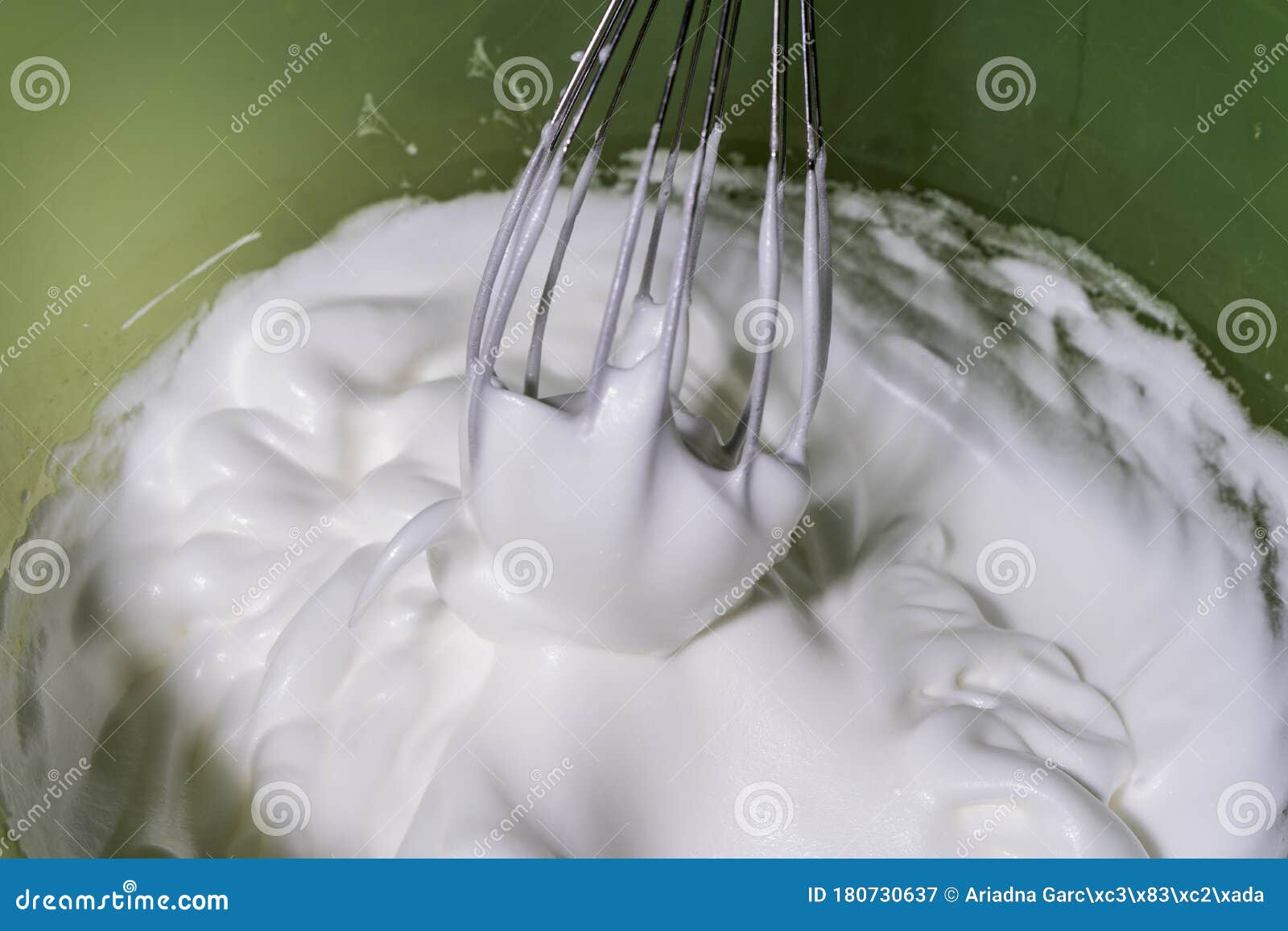 some rods making meringue in a yellow bowl.