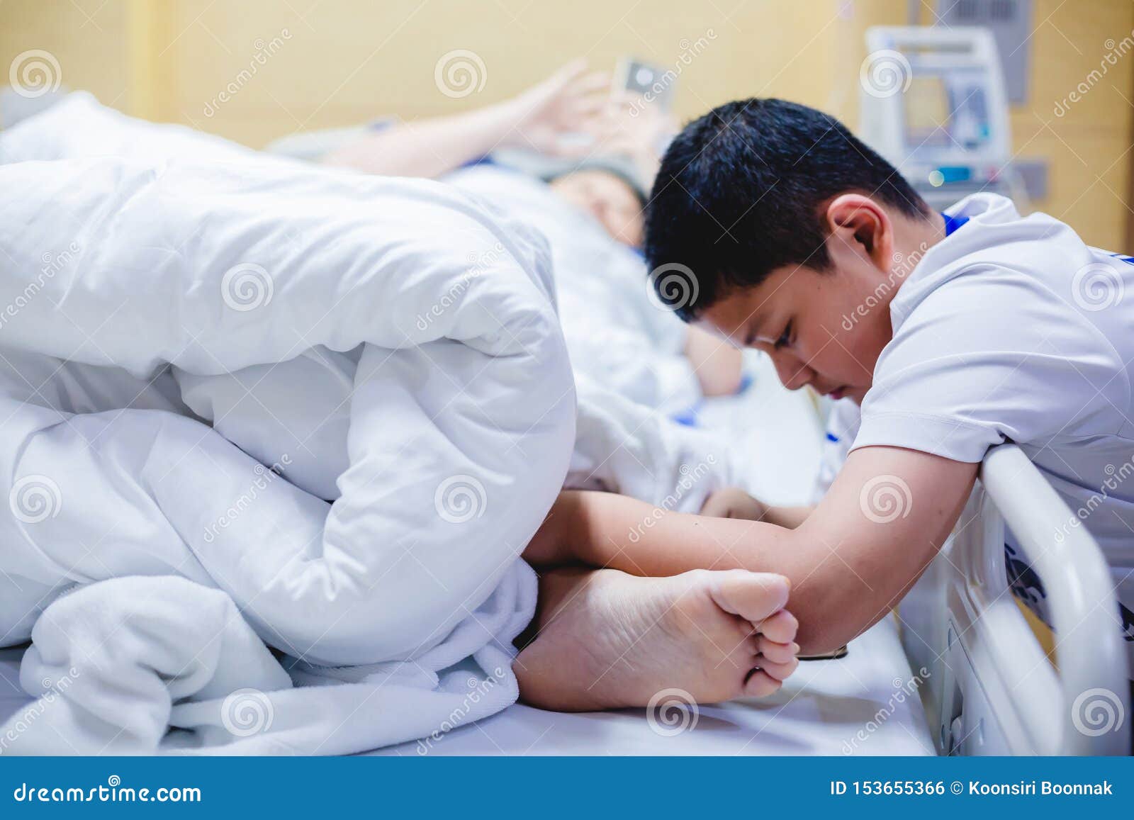 The Son Is Taking Care Of The Sick Mother On The Hospital Bed The Boy